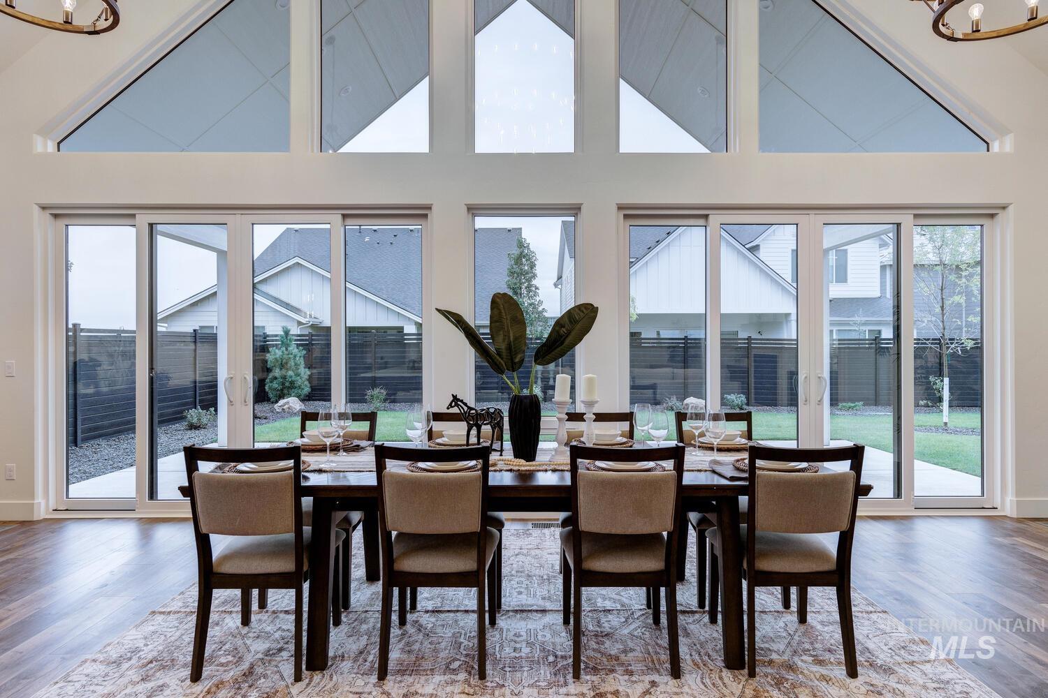Dining room featuring light wood-style flooring and high vaulted ceiling