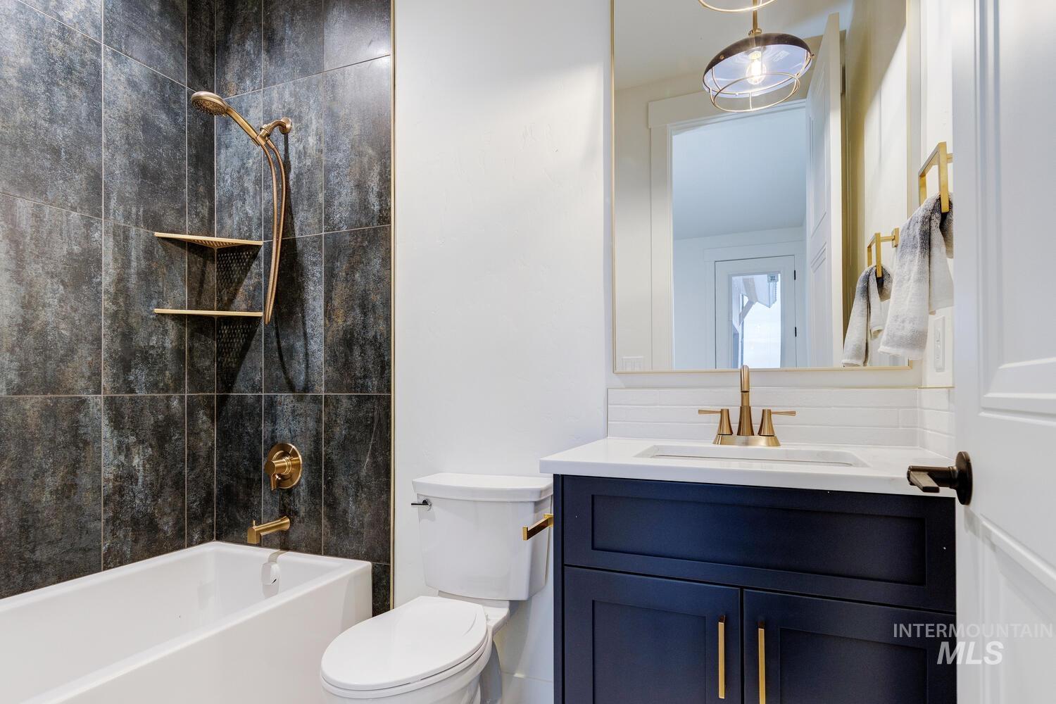 Full bathroom with shower / washtub combination and vanity