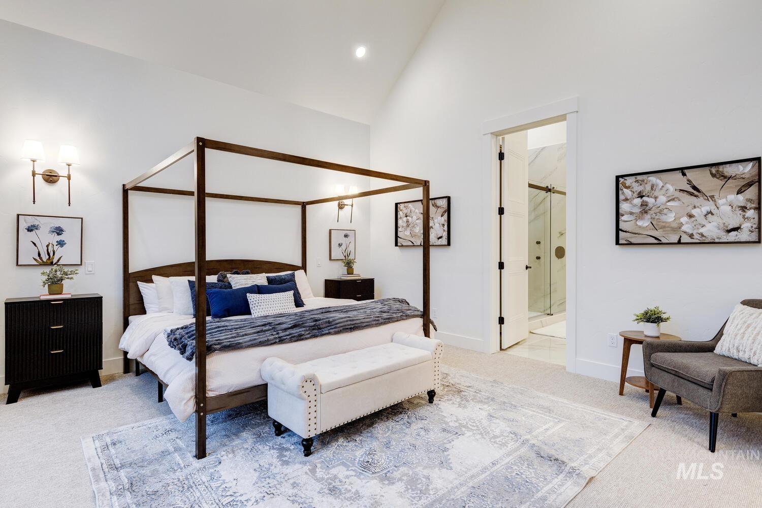 Carpeted bedroom featuring high vaulted ceiling and ensuite bath