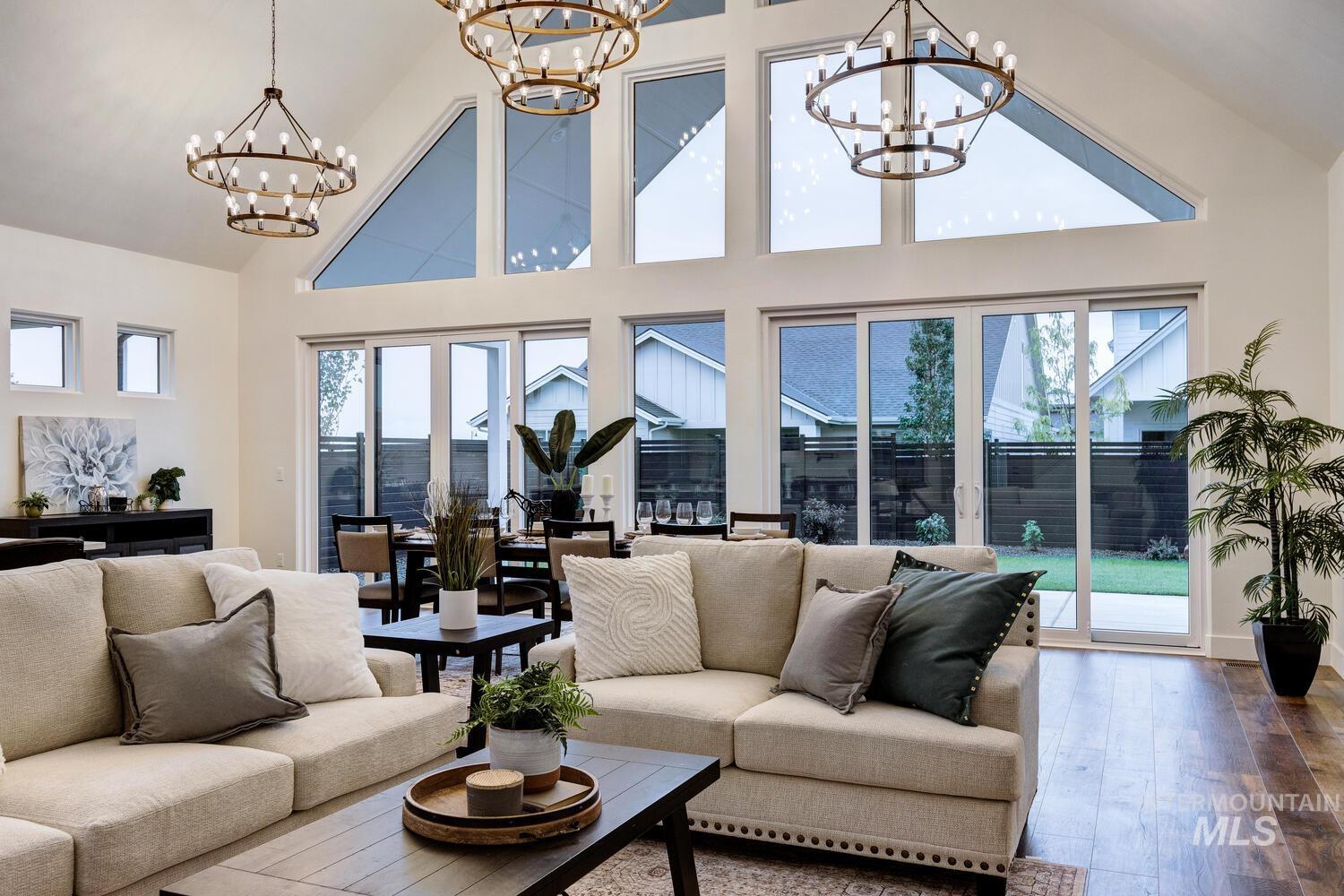 Living room with high vaulted ceiling and wood-type flooring