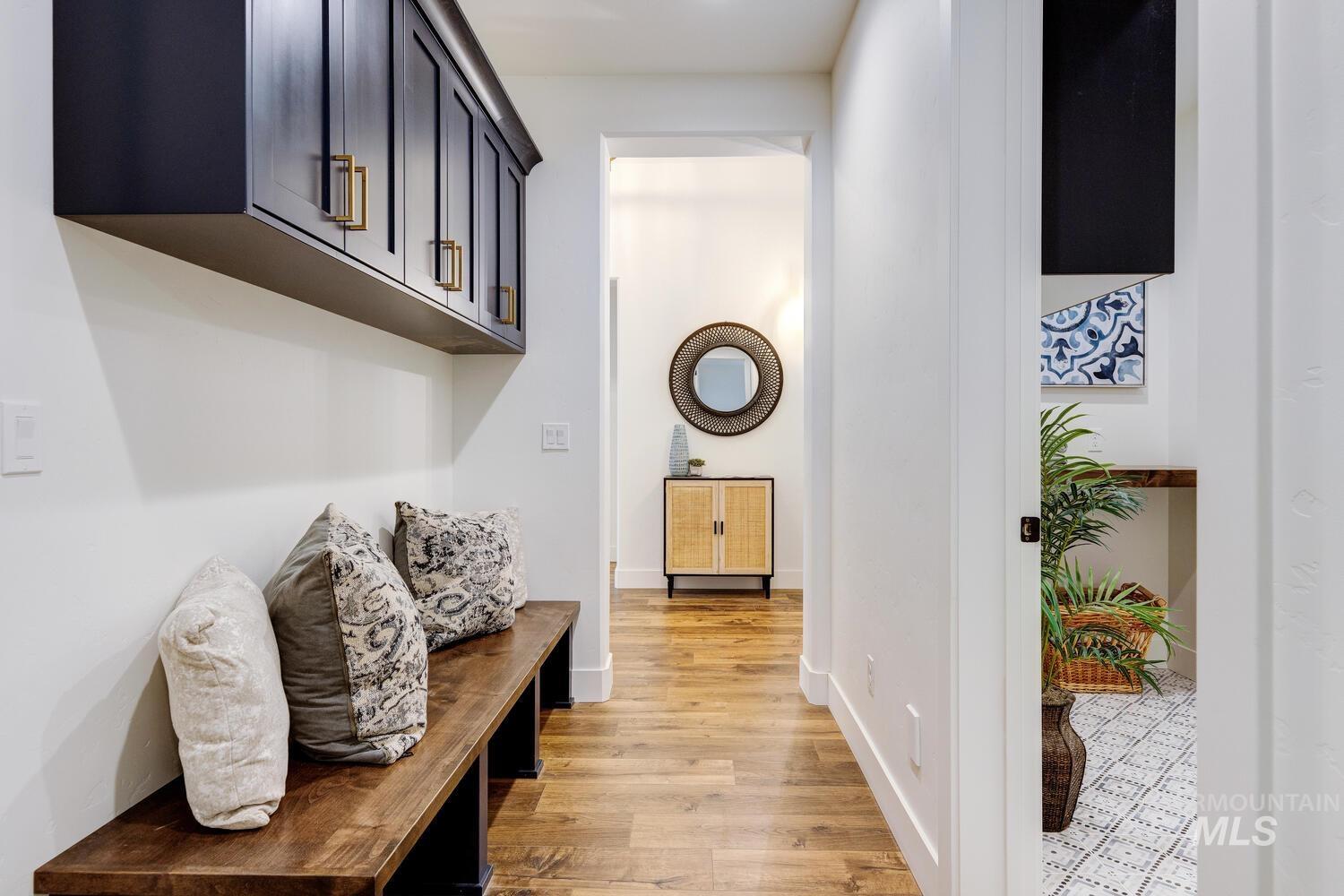 Hallway featuring light wood-type flooring and baseboards