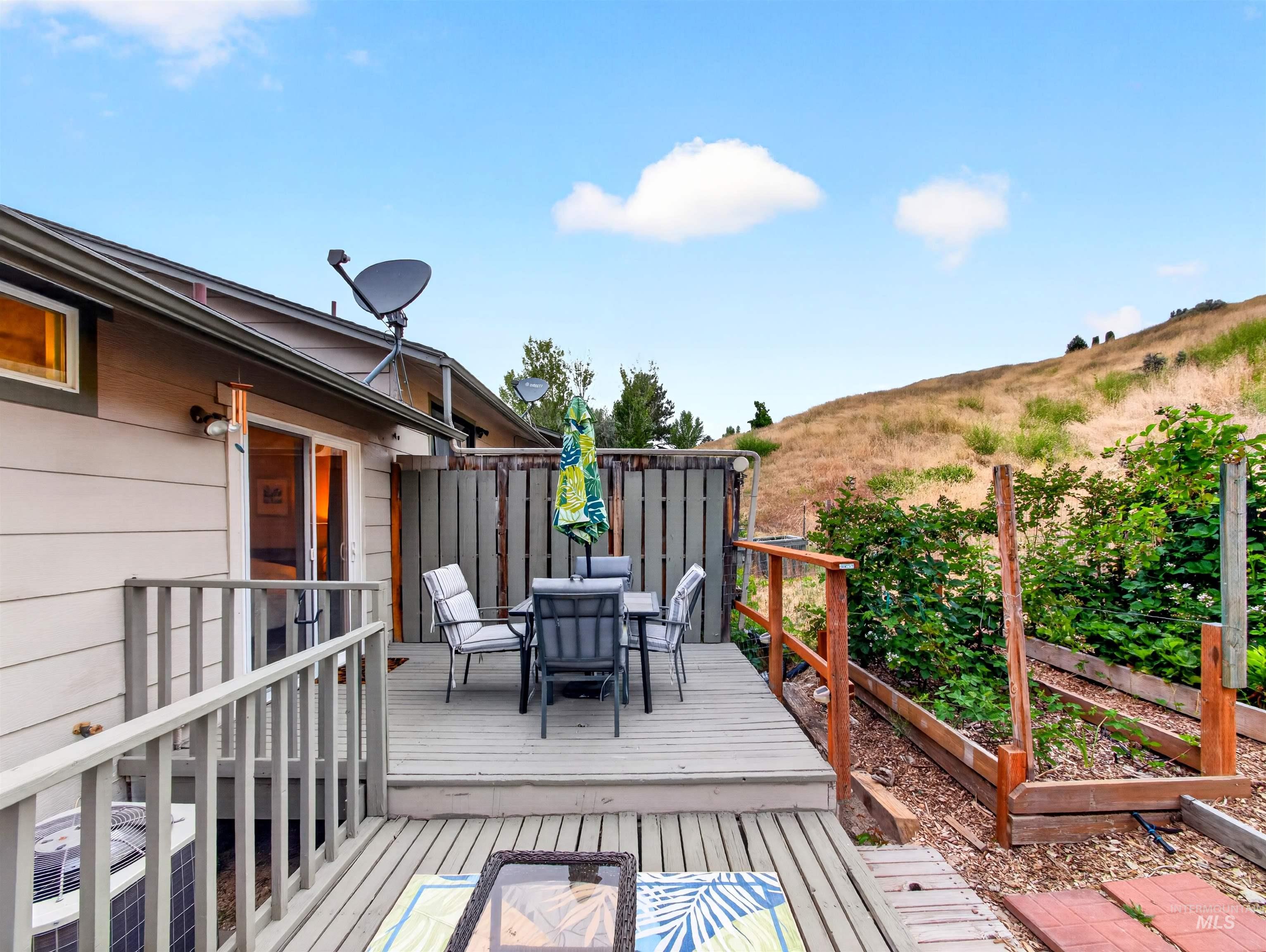 Multi-level exterior deck featuring wood railing and steps
