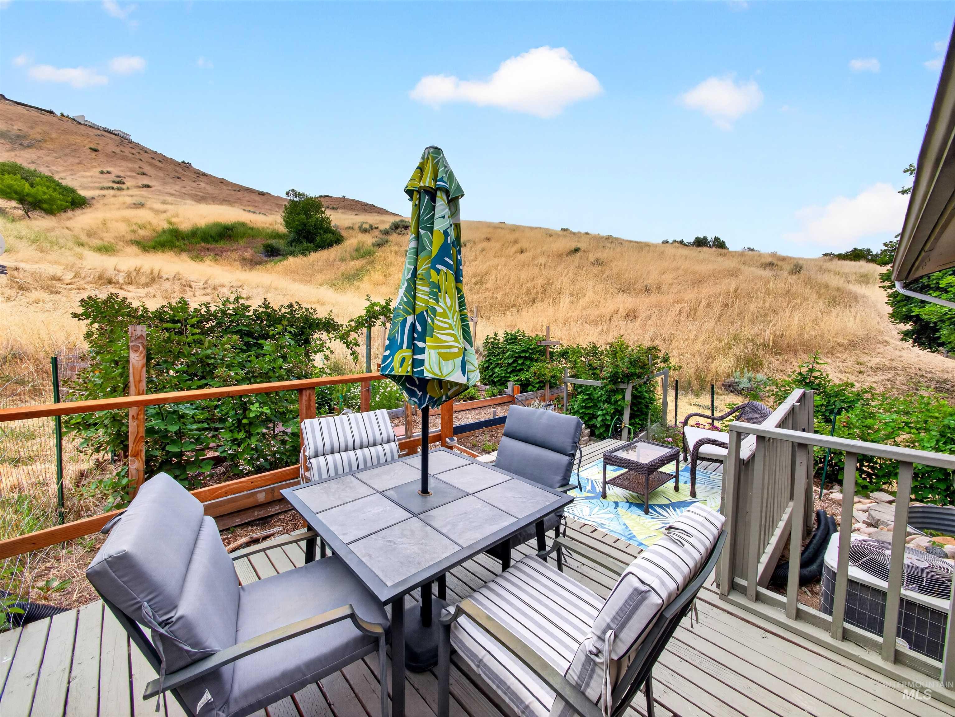 Spacious outdoor deck featuring natural wood railings and a composite wood-finish surface