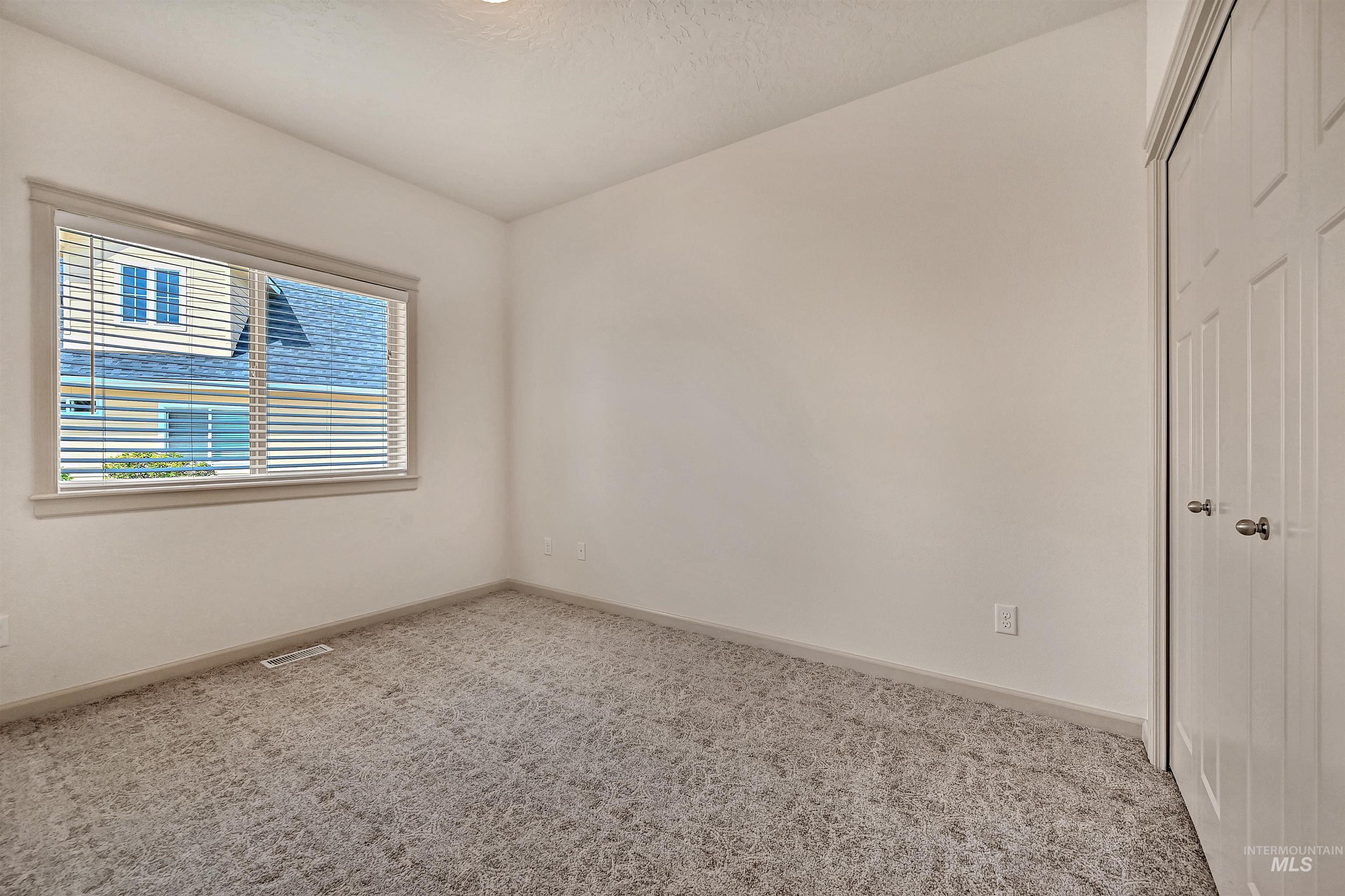 Unfurnished bedroom featuring a closet and carpet