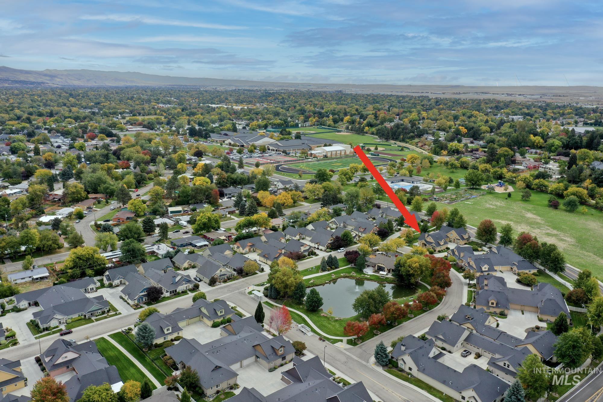 Aerial view of property's location featuring nearby suburban area and a nearby body of water