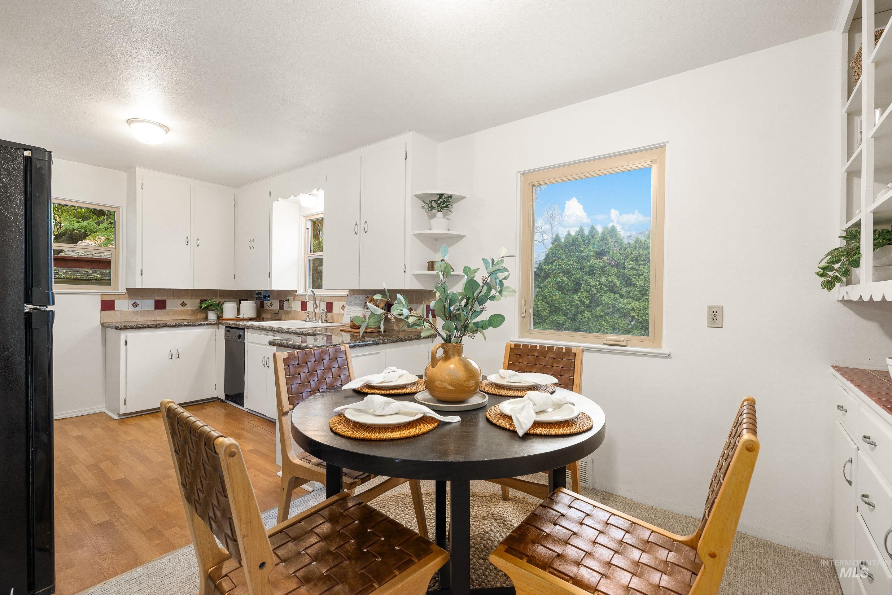 Dining space featuring light wood-type flooring and plenty of natural light