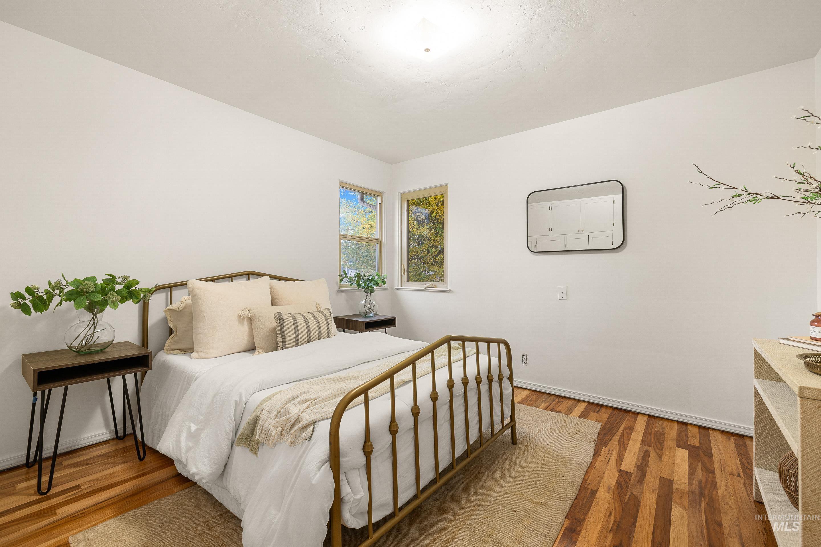 Bedroom with light wood-type flooring and baseboards