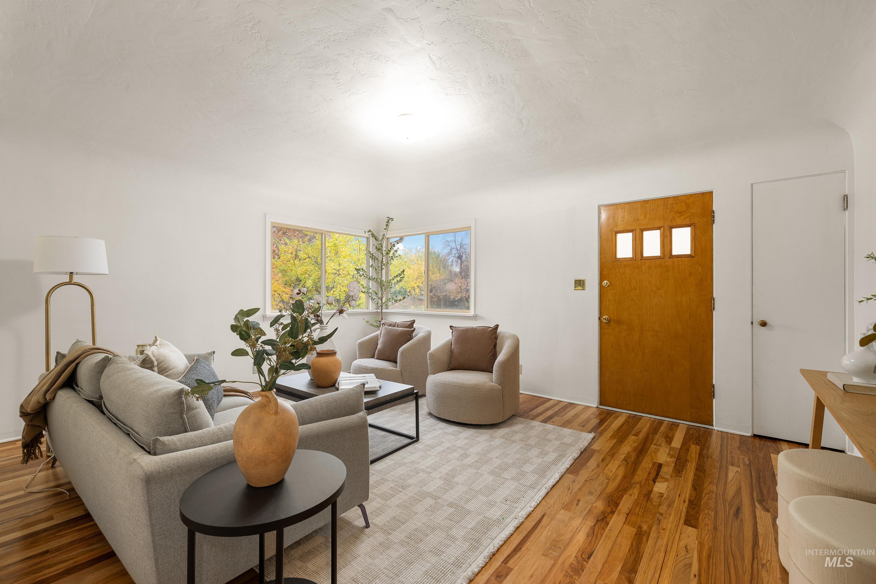 Living room with wood finished floors and a textured ceiling