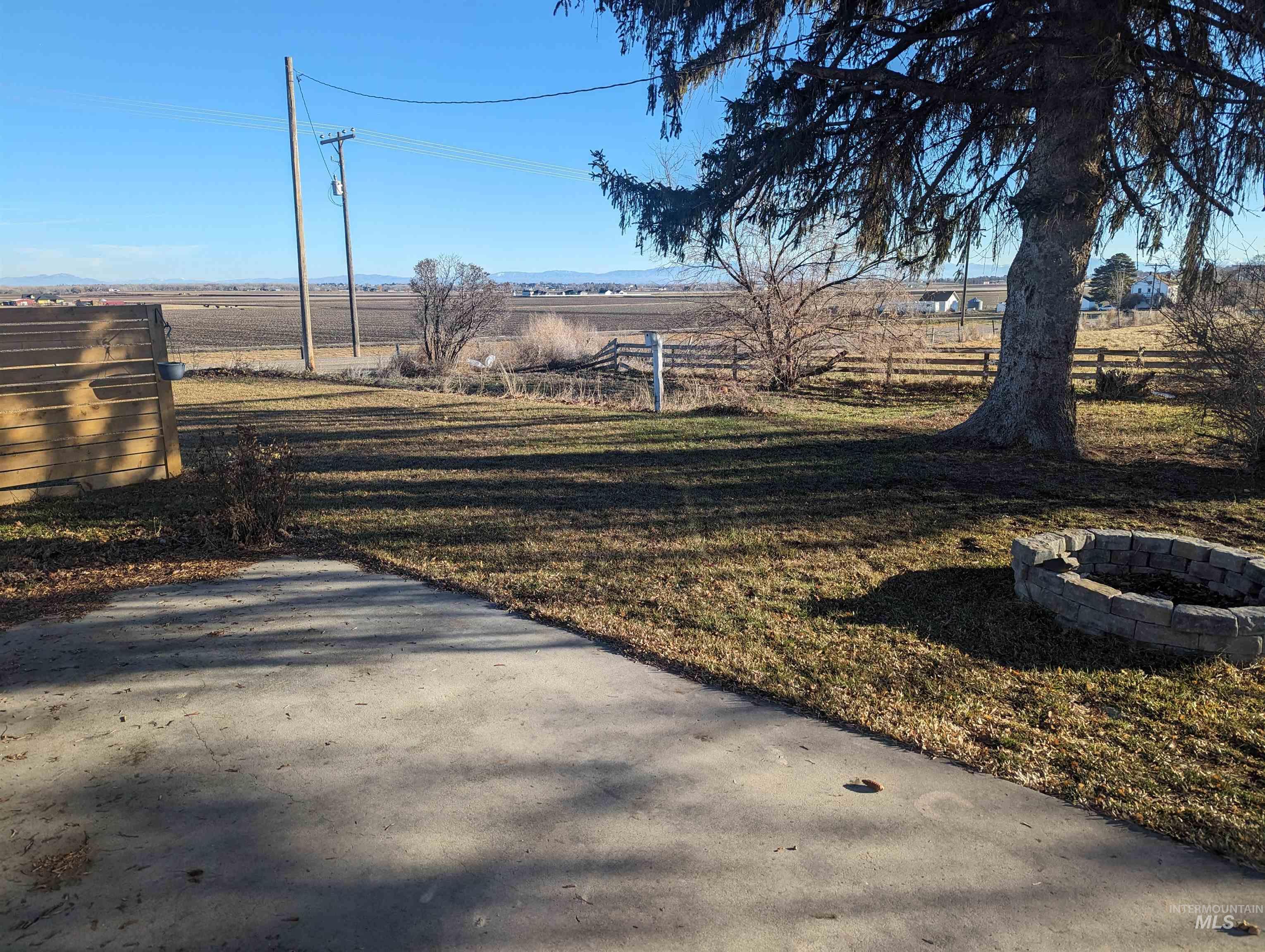 View of yard with a view of rural / pastoral area and a fire pit