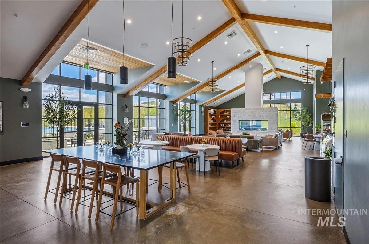 Vaulted ceilings with exposed wood beams define this expansive common area