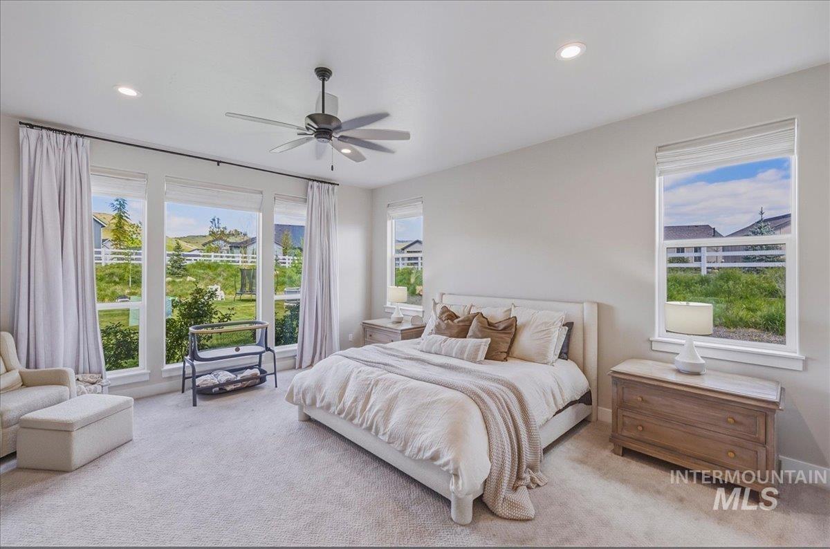 Bright bedroom with light-colored walls and carpeted flooring