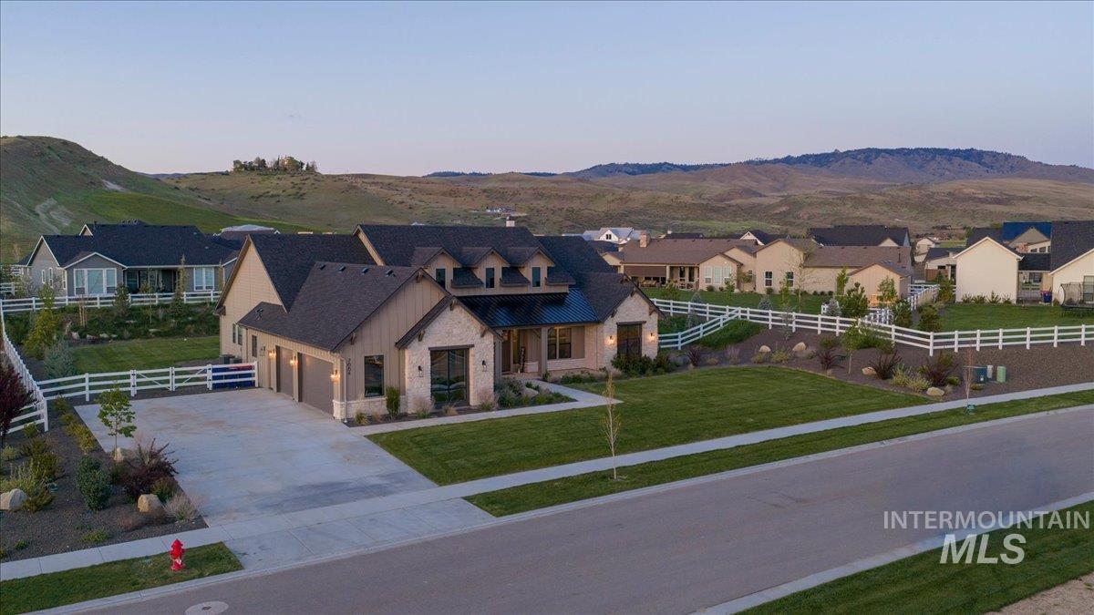 Contemporary craftsman-style residence featuring a stone and board-and-batten facade