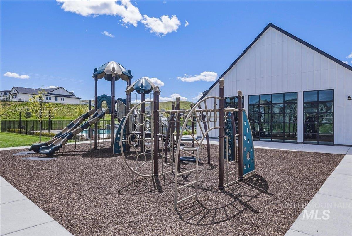 Community playground featuring multiple slides, climbing structures, and protective ground cover
