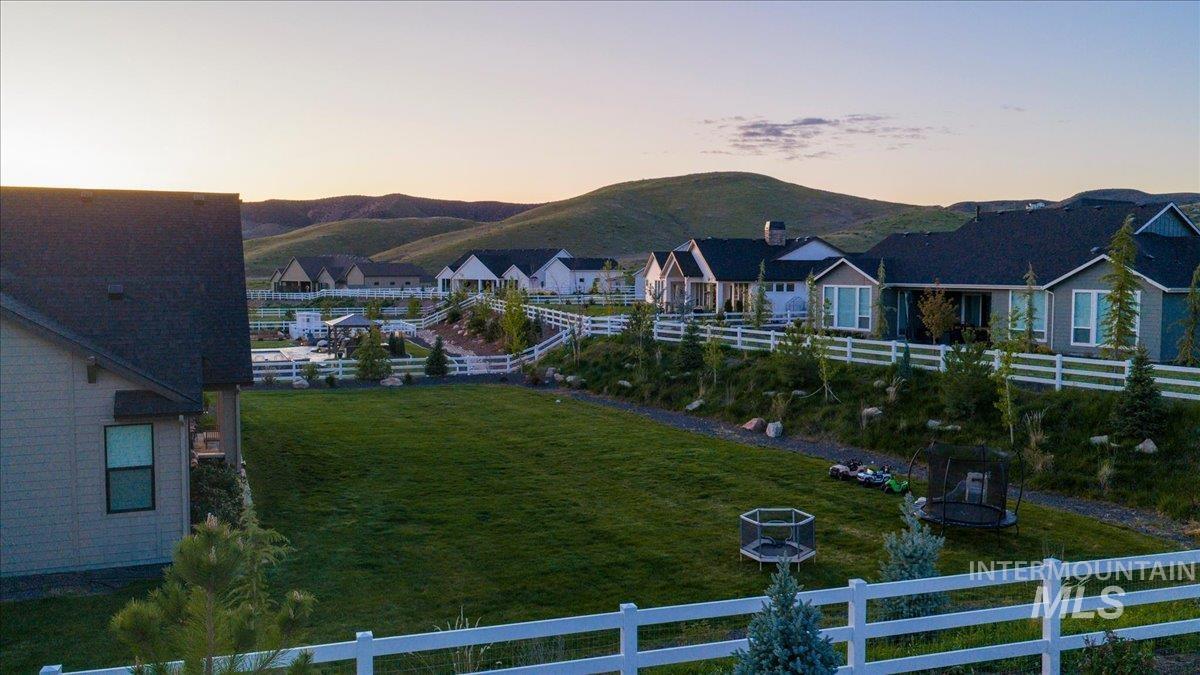 Expansive green lawn with a white post-and-rail fence