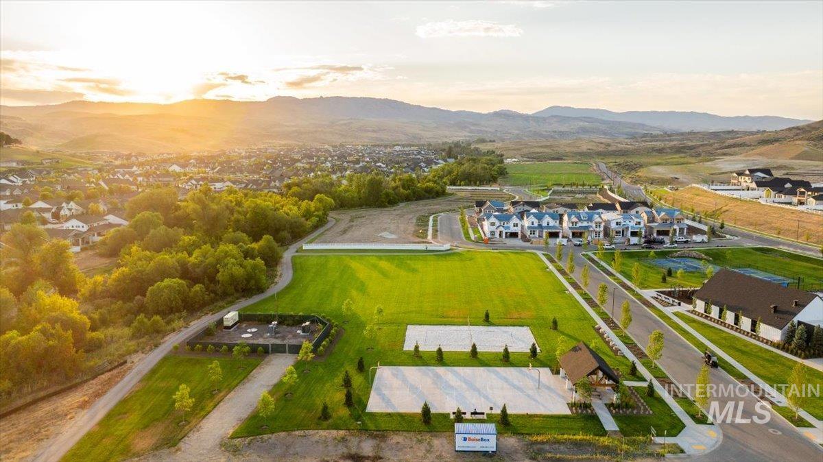 Expansive community green space featuring two sand volleyball courts and a dedicated recreational field