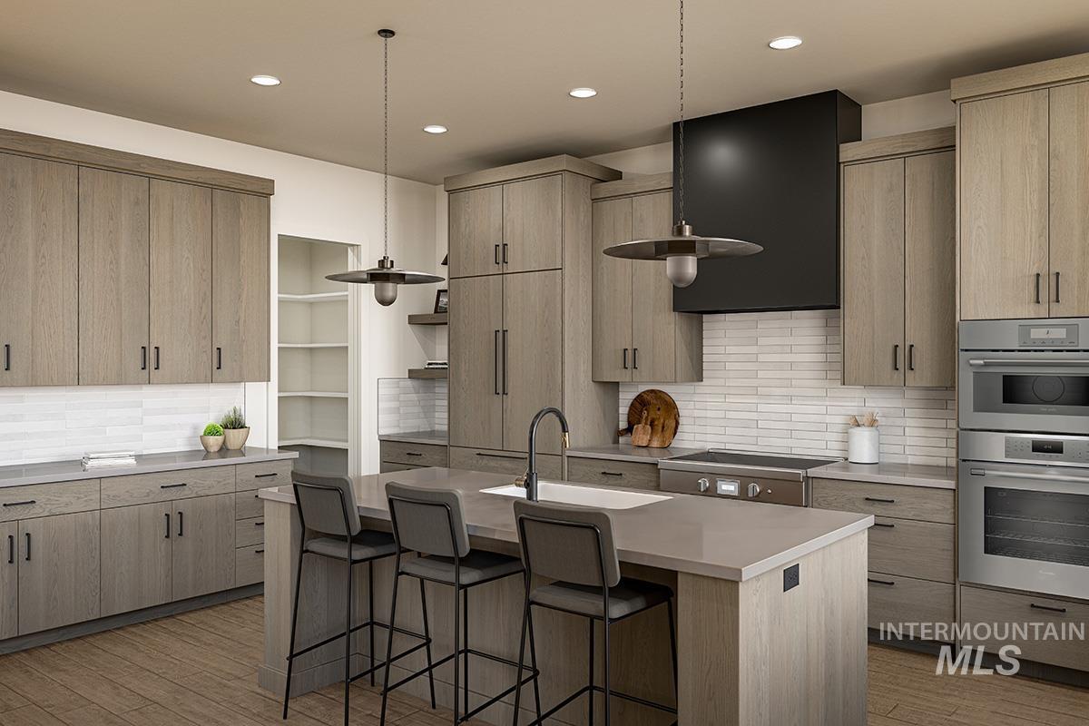 Kitchen featuring tasteful backsplash, modern cabinets, light brown cabinetry, and recessed lighting