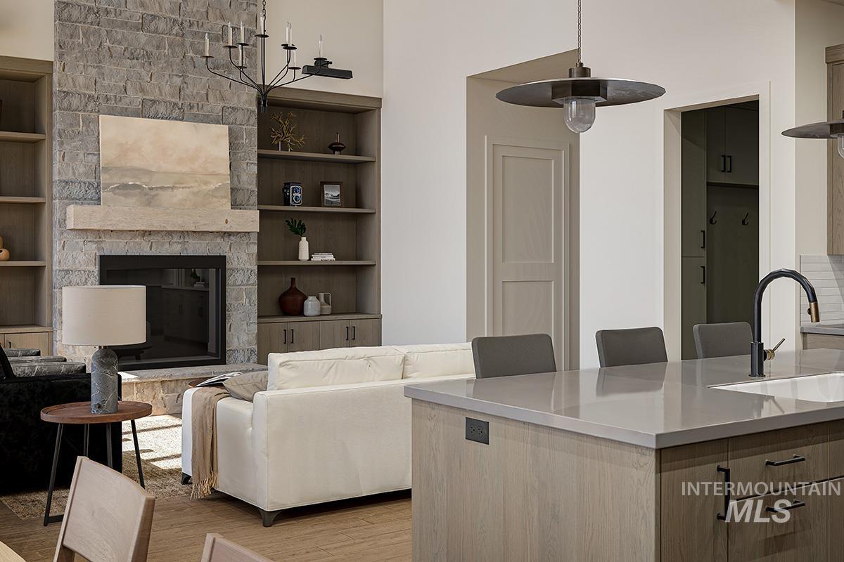 Living area with light wood-style flooring, a fireplace, and built in shelves