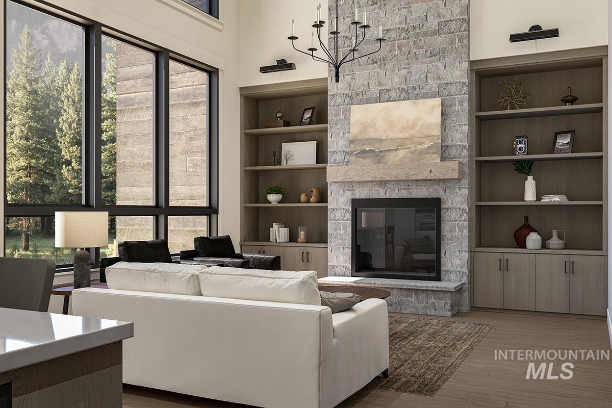 Living room featuring a fireplace, wood finished floors, and built in shelves