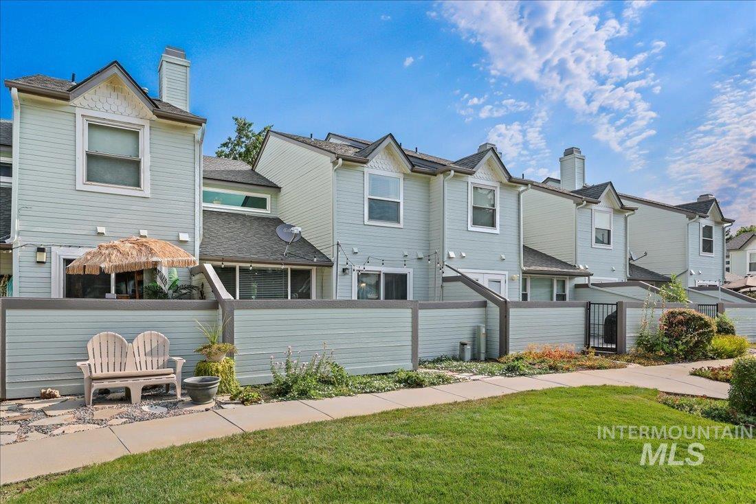 Rear view of property featuring a residential view and a chimney