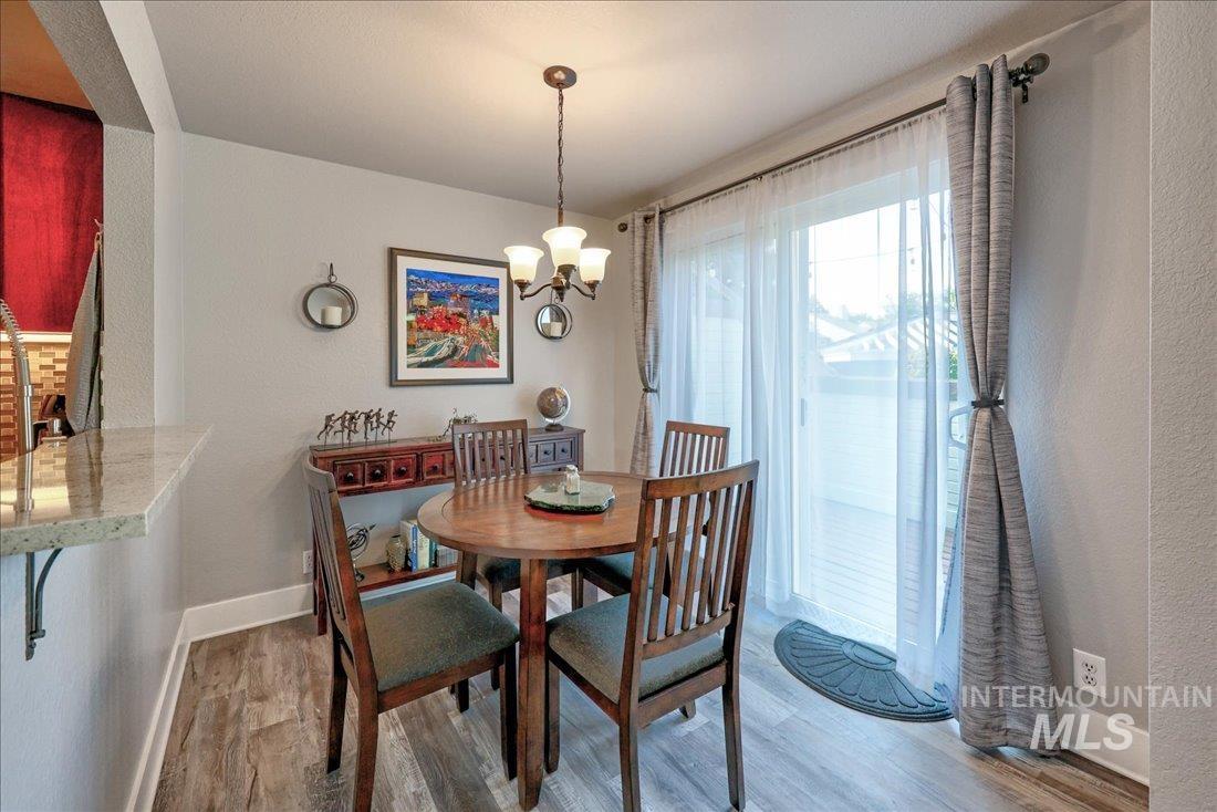 Dining area featuring wood finished floors and a chandelier