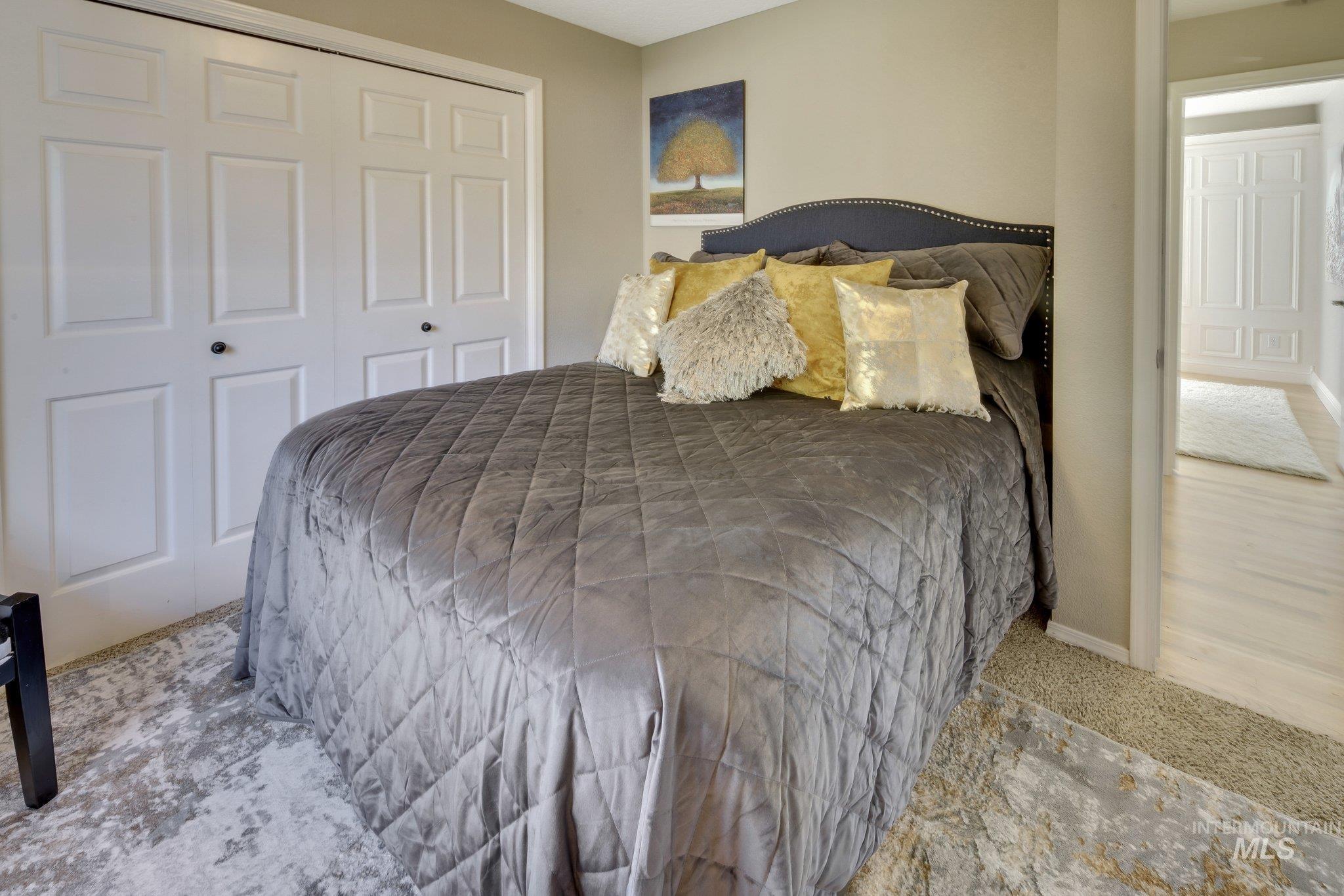 Carpeted bedroom with a closet and baseboards
