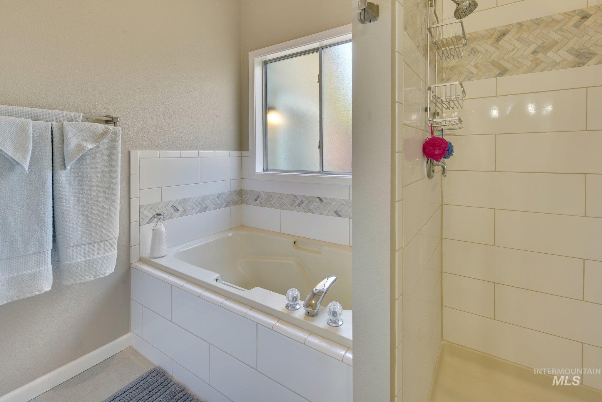 Full bath with a bath and a stall shower