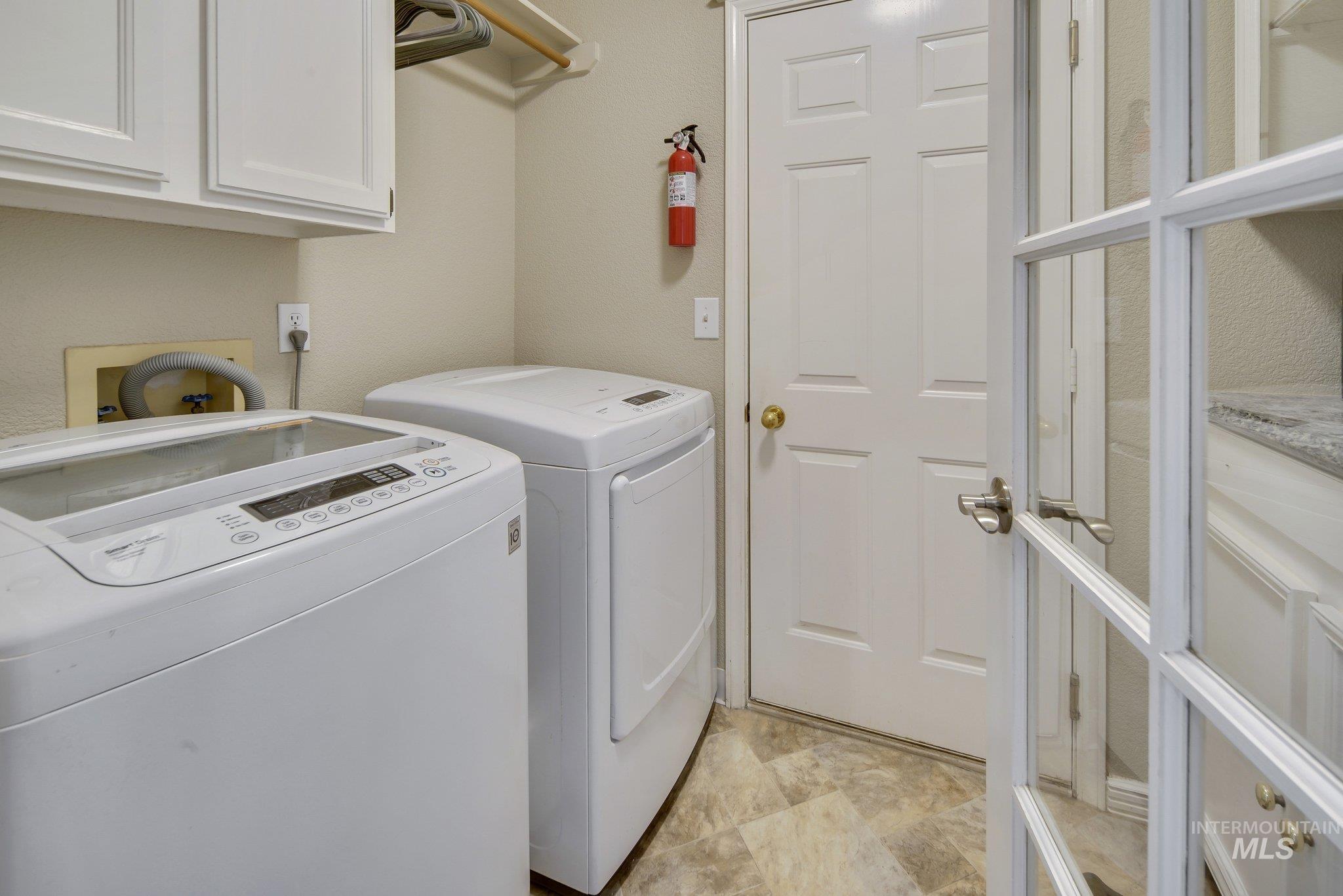 Laundry room with cabinet space and separate washer and dryer