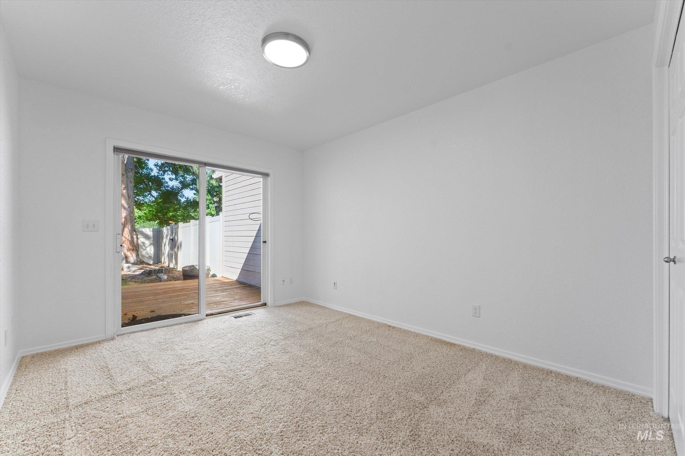 Spare room featuring carpet flooring and a textured ceiling