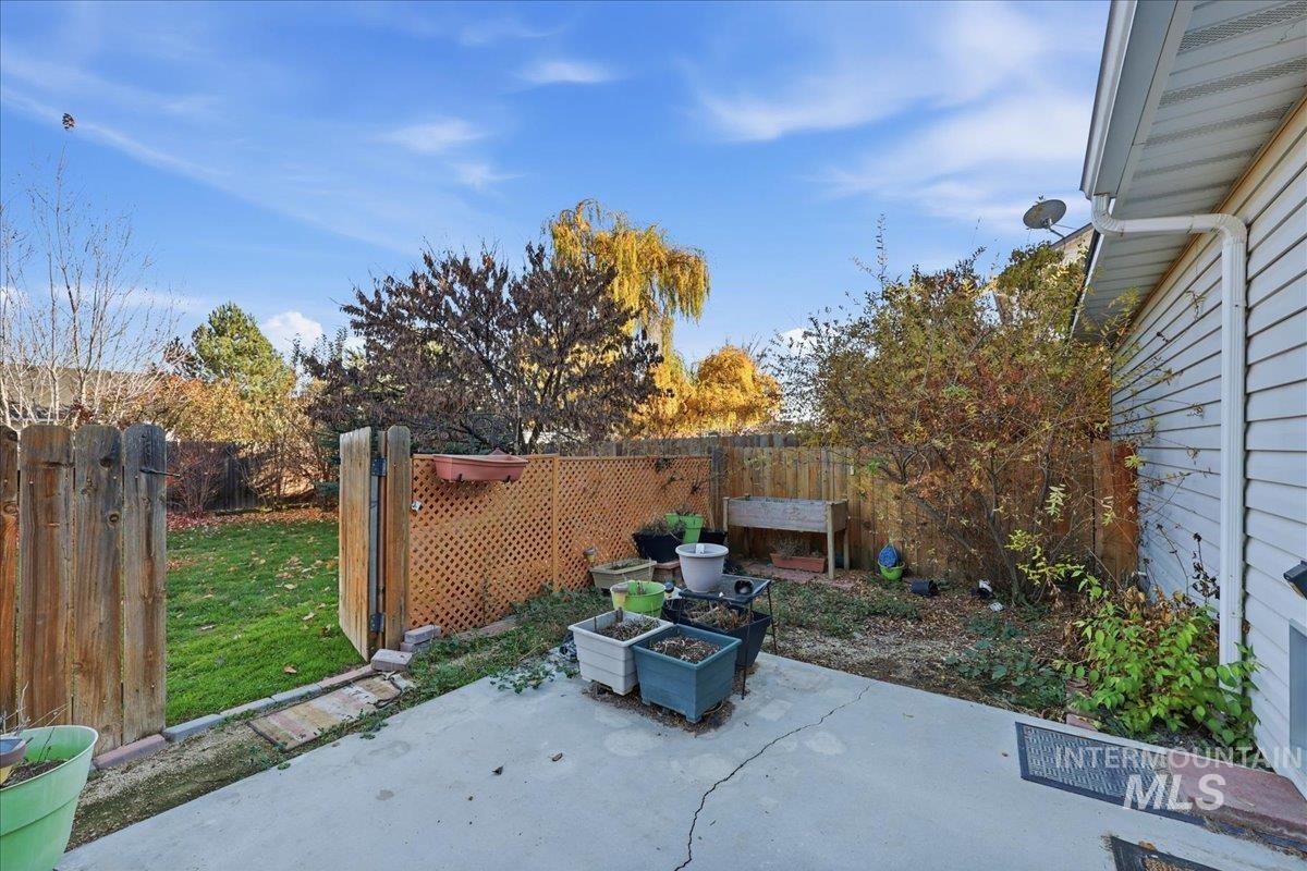 Fenced backyard with a patio