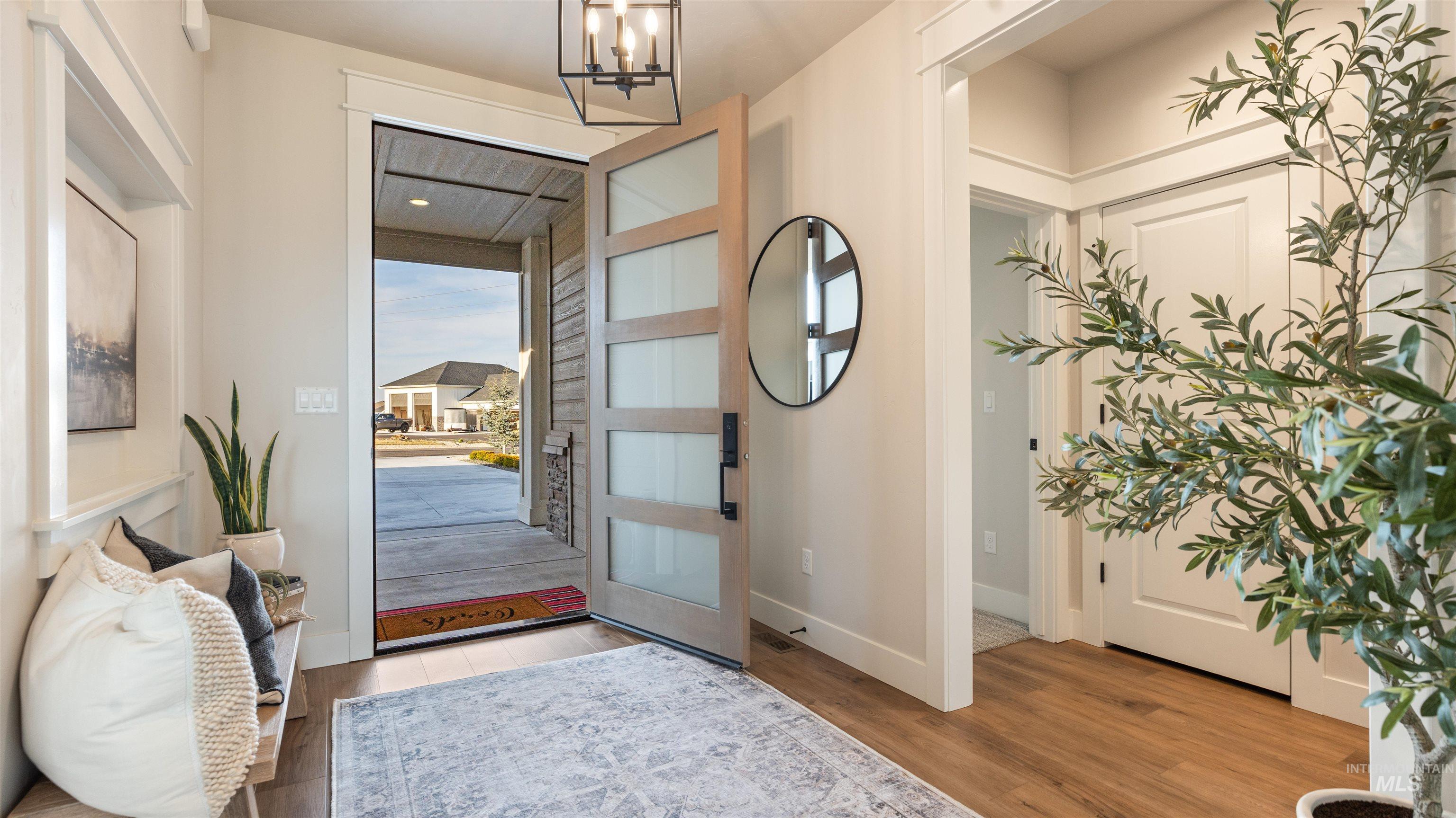 Entrance foyer featuring light wood-style flooring and a chandelier