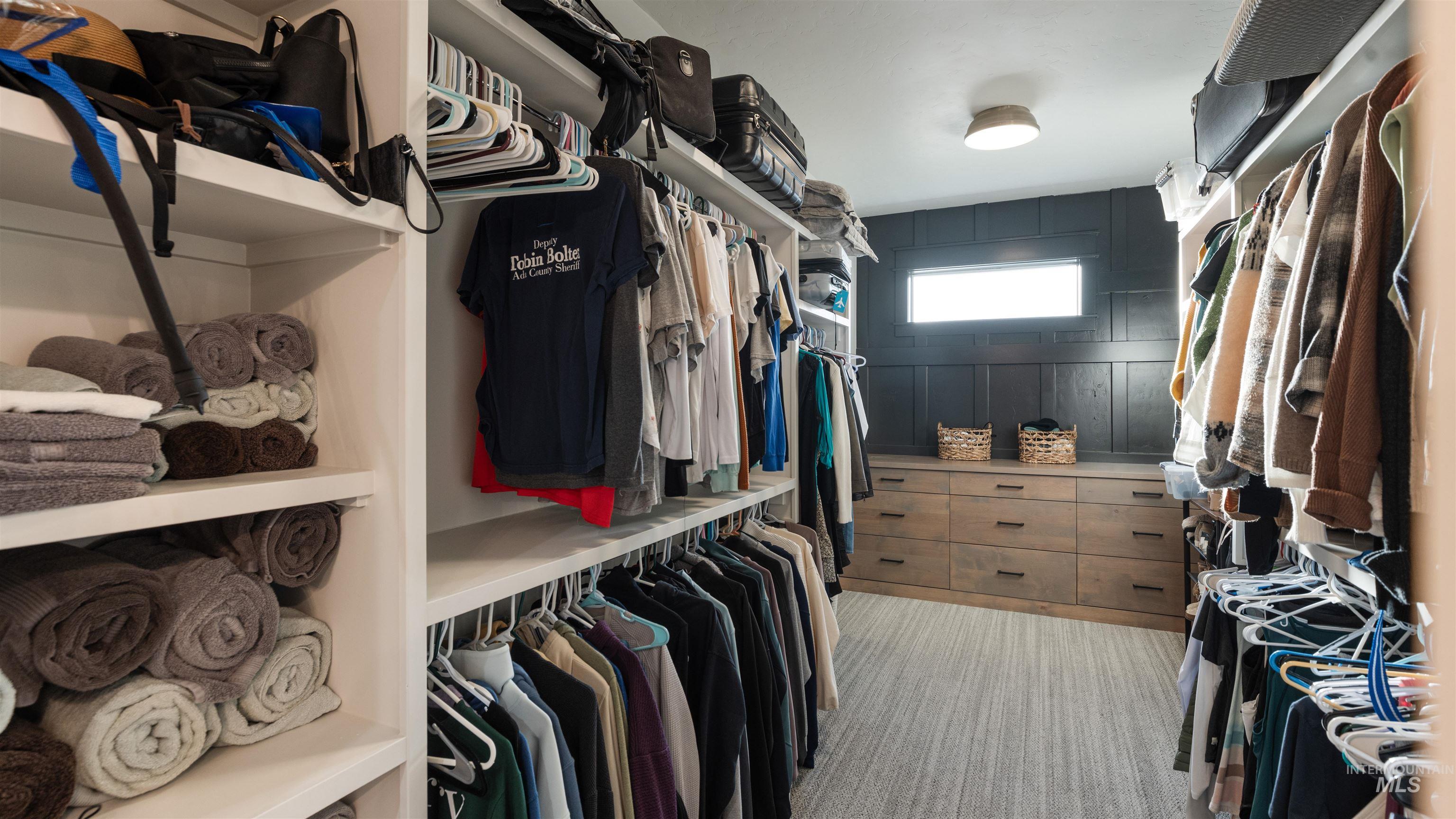 Walk in closet featuring light carpet