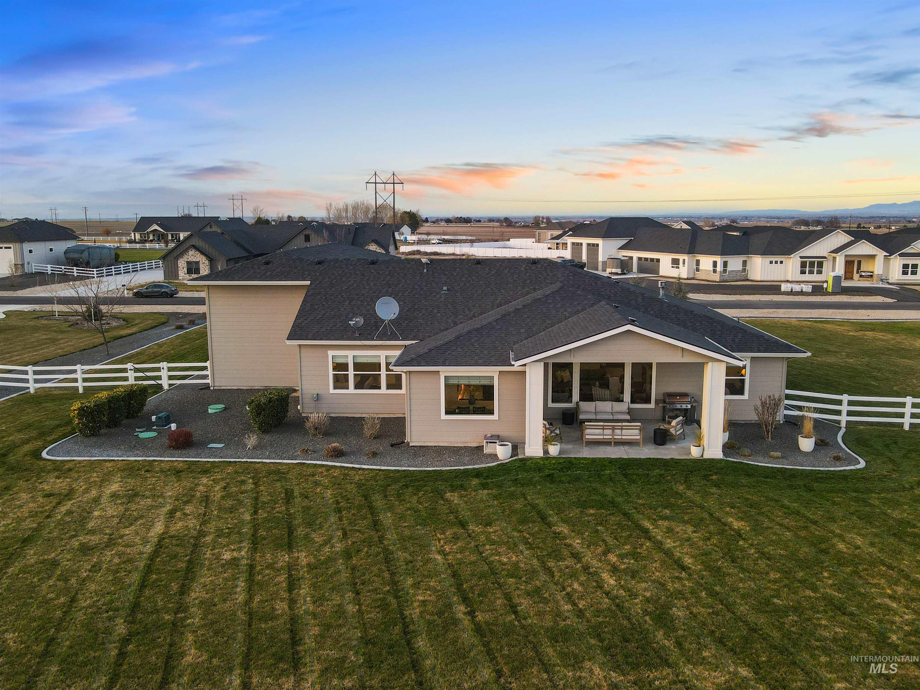 Rear view of house featuring a fenced backyard, outdoor seating, a patio area, and a residential view
