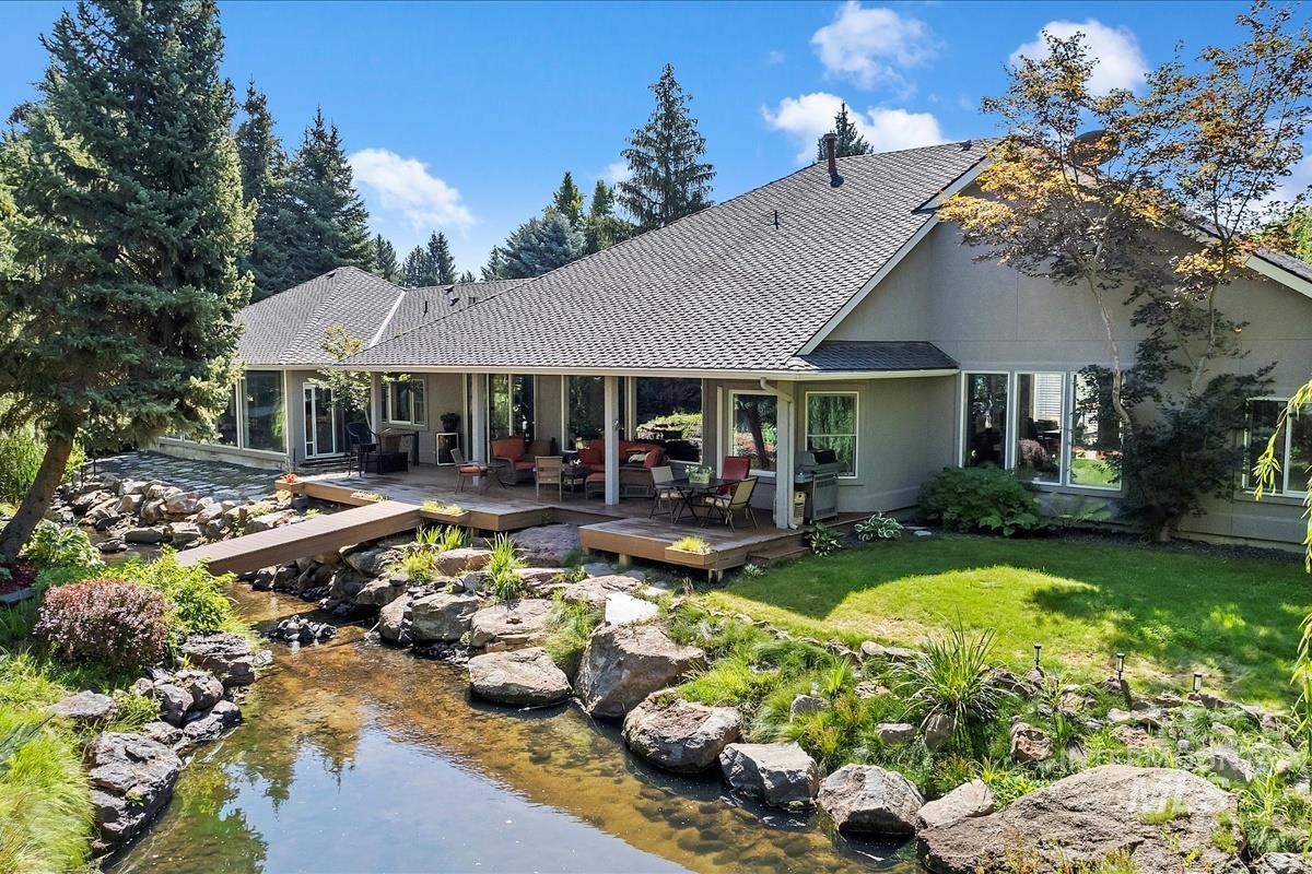 Back of property featuring a yard and a deck