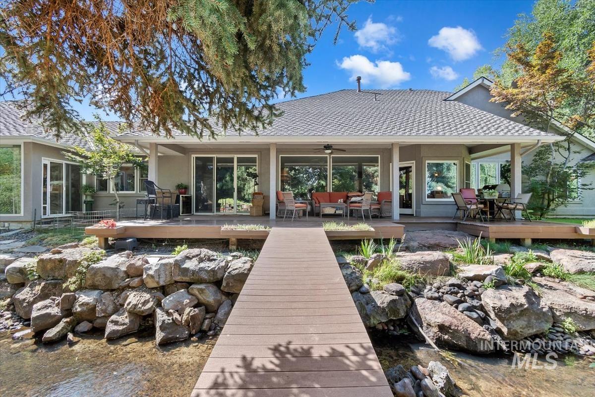 Rear view of house with an outdoor hangout area, roof with shingles, ceiling fan, a wooden deck, and a patio area