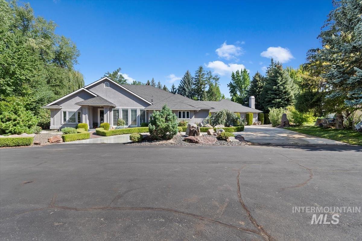 View of front of home with driveway and a chimney