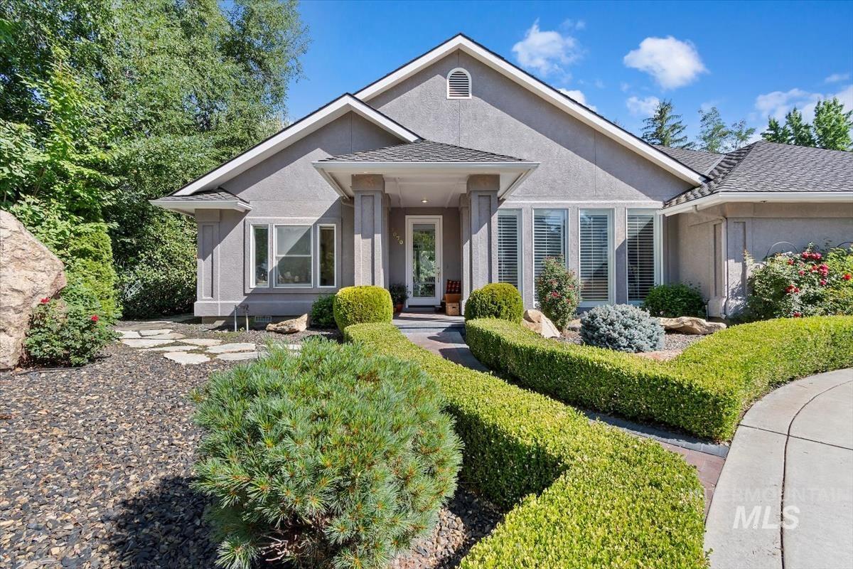 View of front of property with stucco siding and roof with shingles