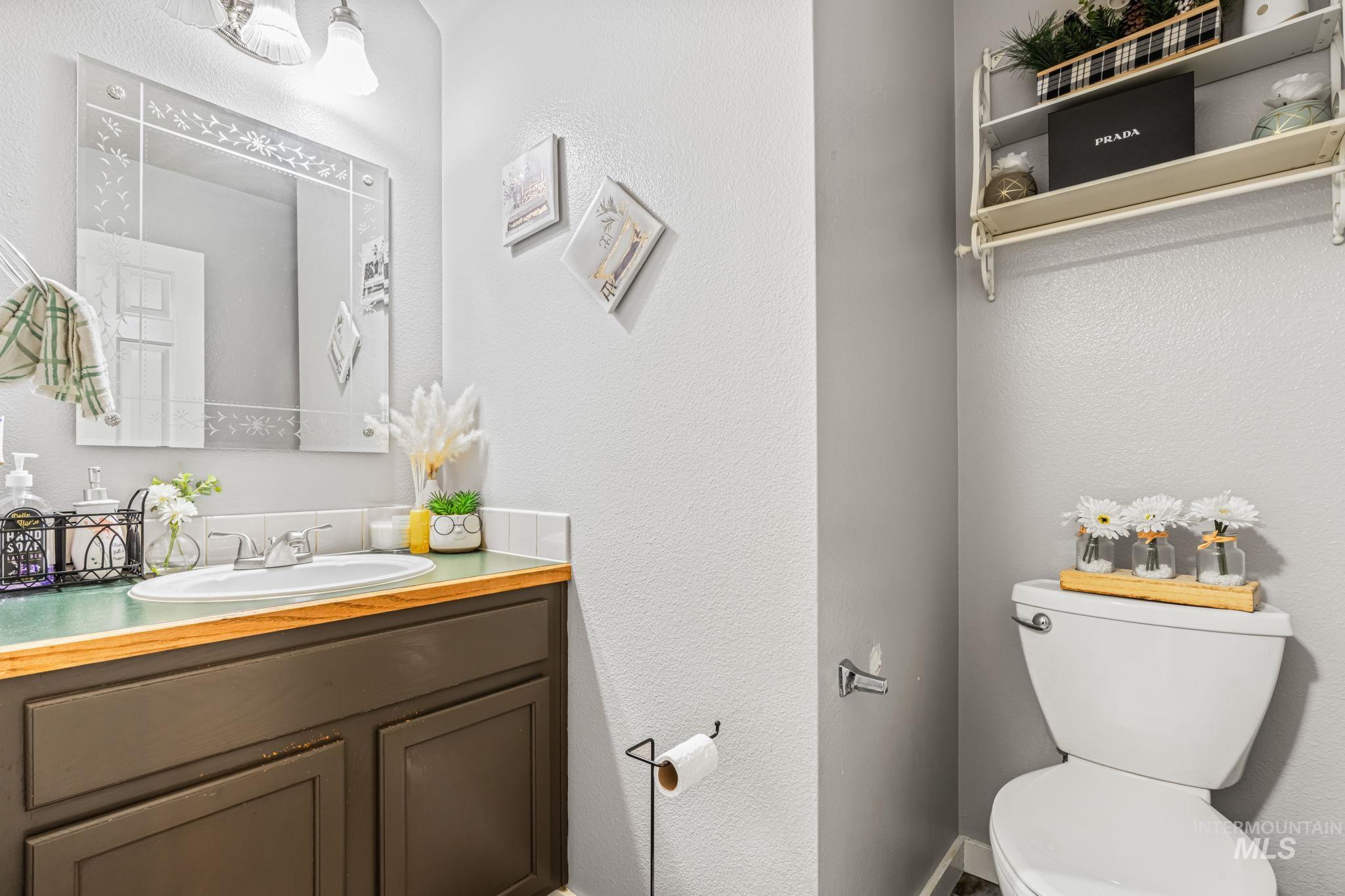 Bathroom with a textured wall and vanity