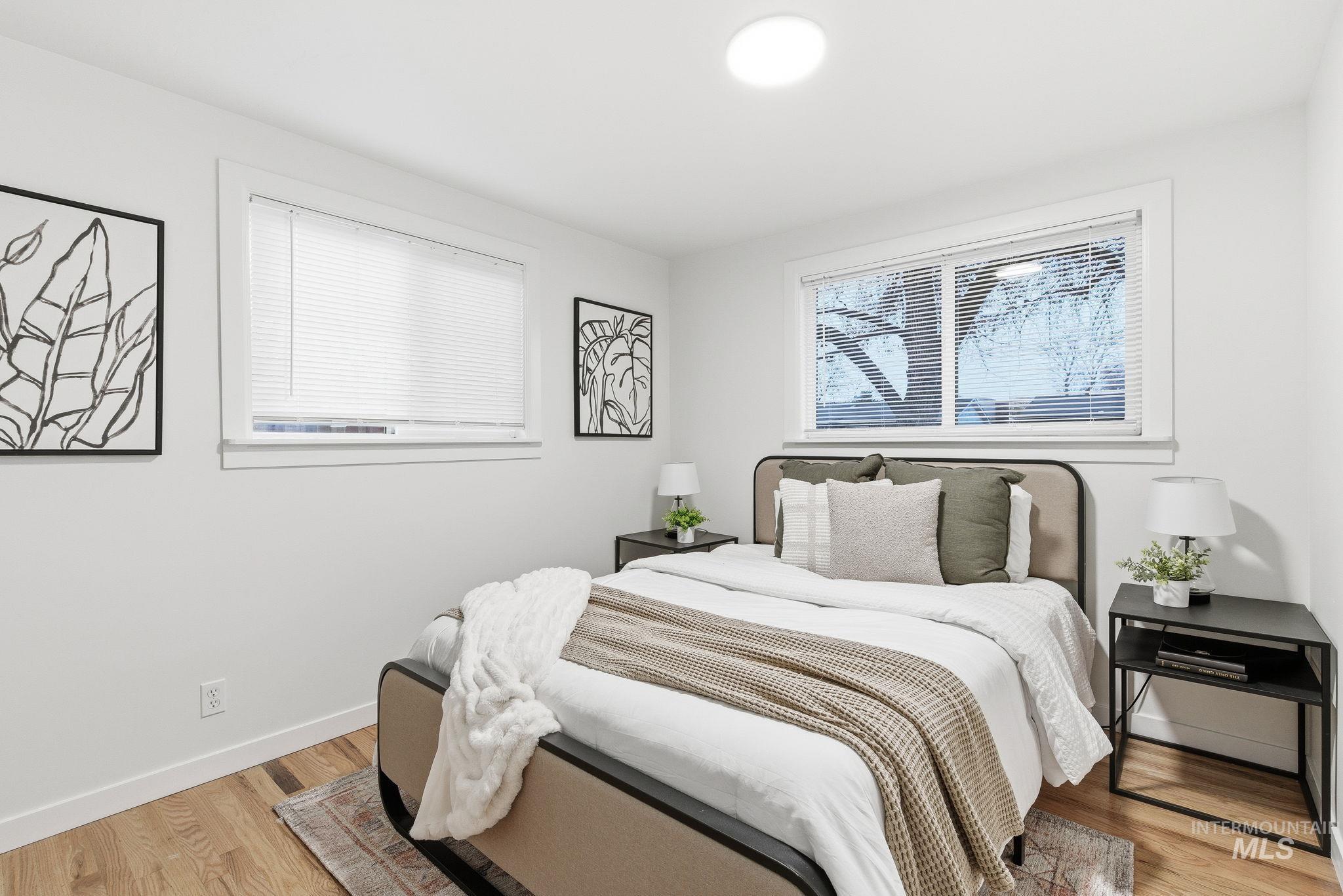 Bedroom with light wood-style floors and baseboards