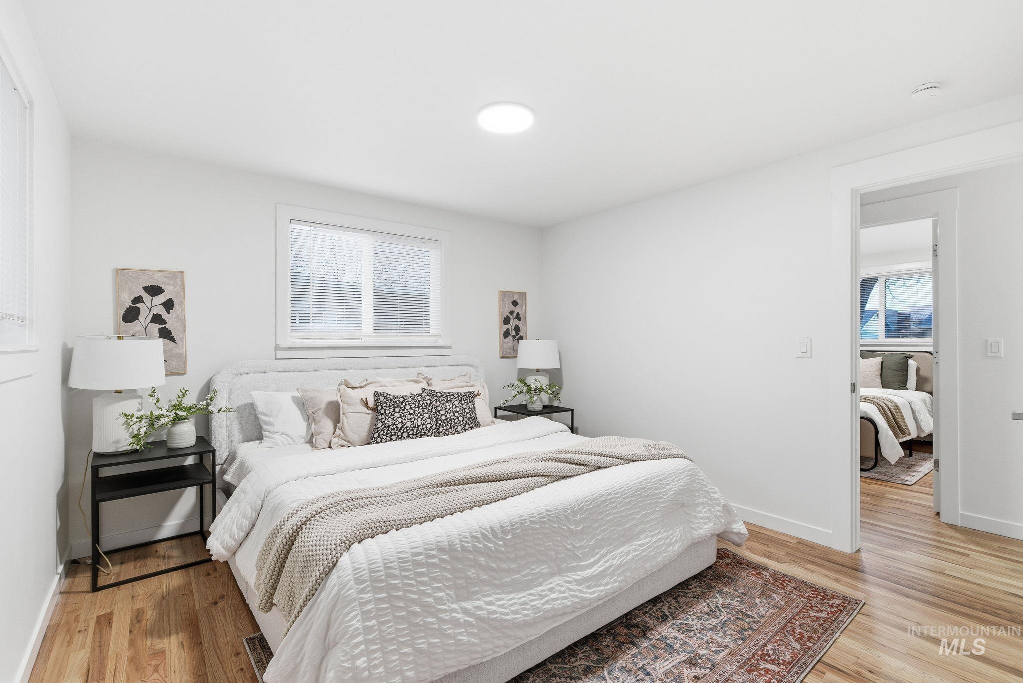 Bedroom featuring multiple windows and light wood finished floors