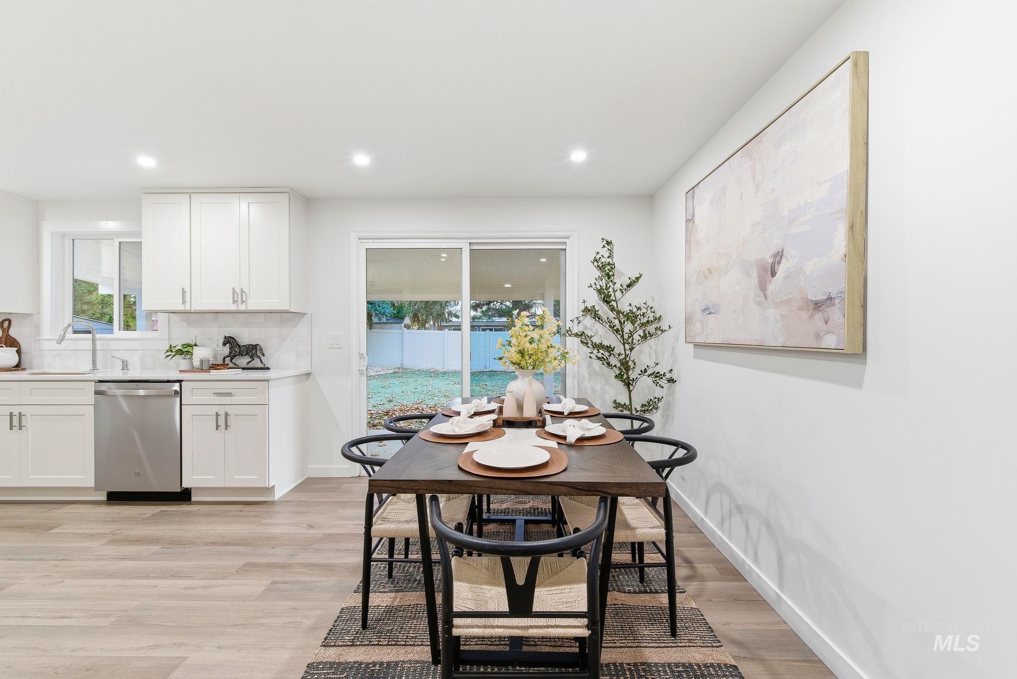 Dining room featuring light wood-type flooring, plenty of natural light, and recessed lighting