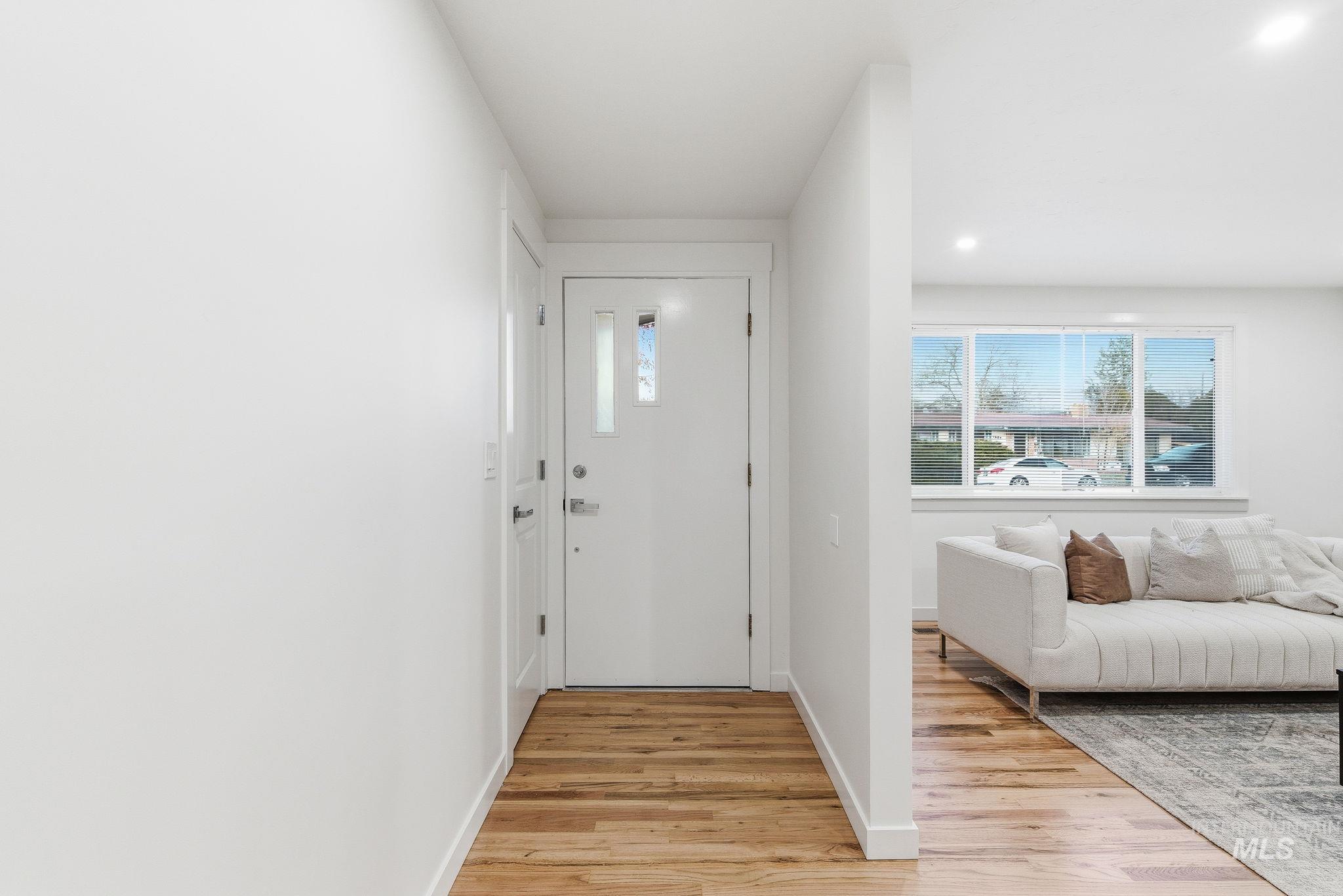 Entryway featuring light wood-type flooring and recessed lighting