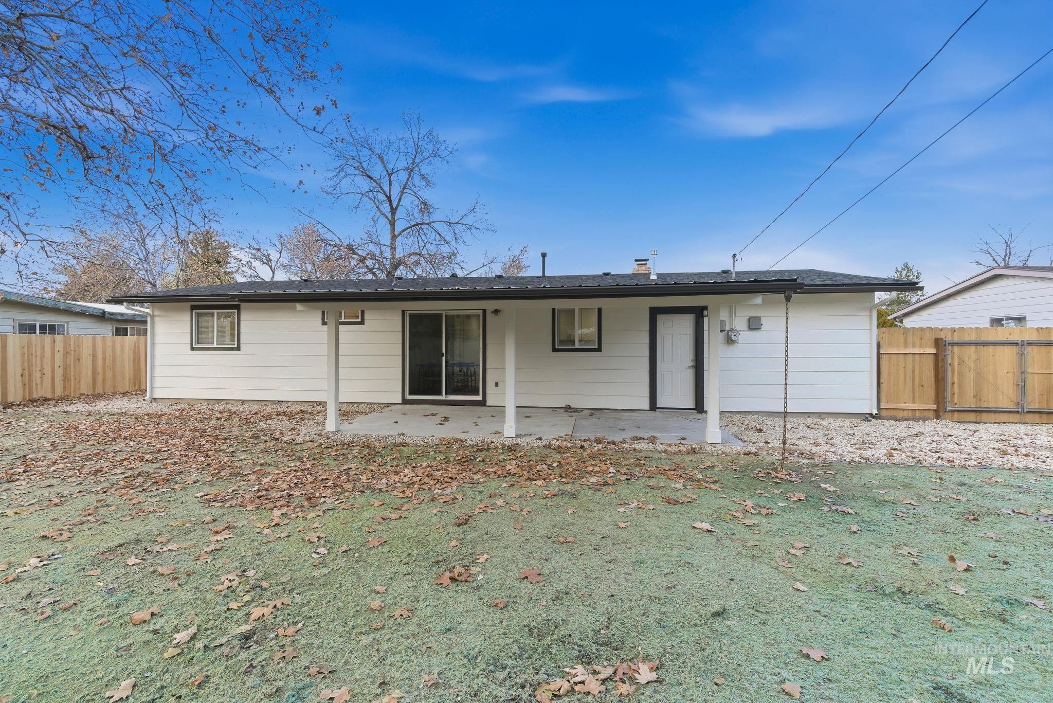 Back of property featuring a fenced backyard and a patio area