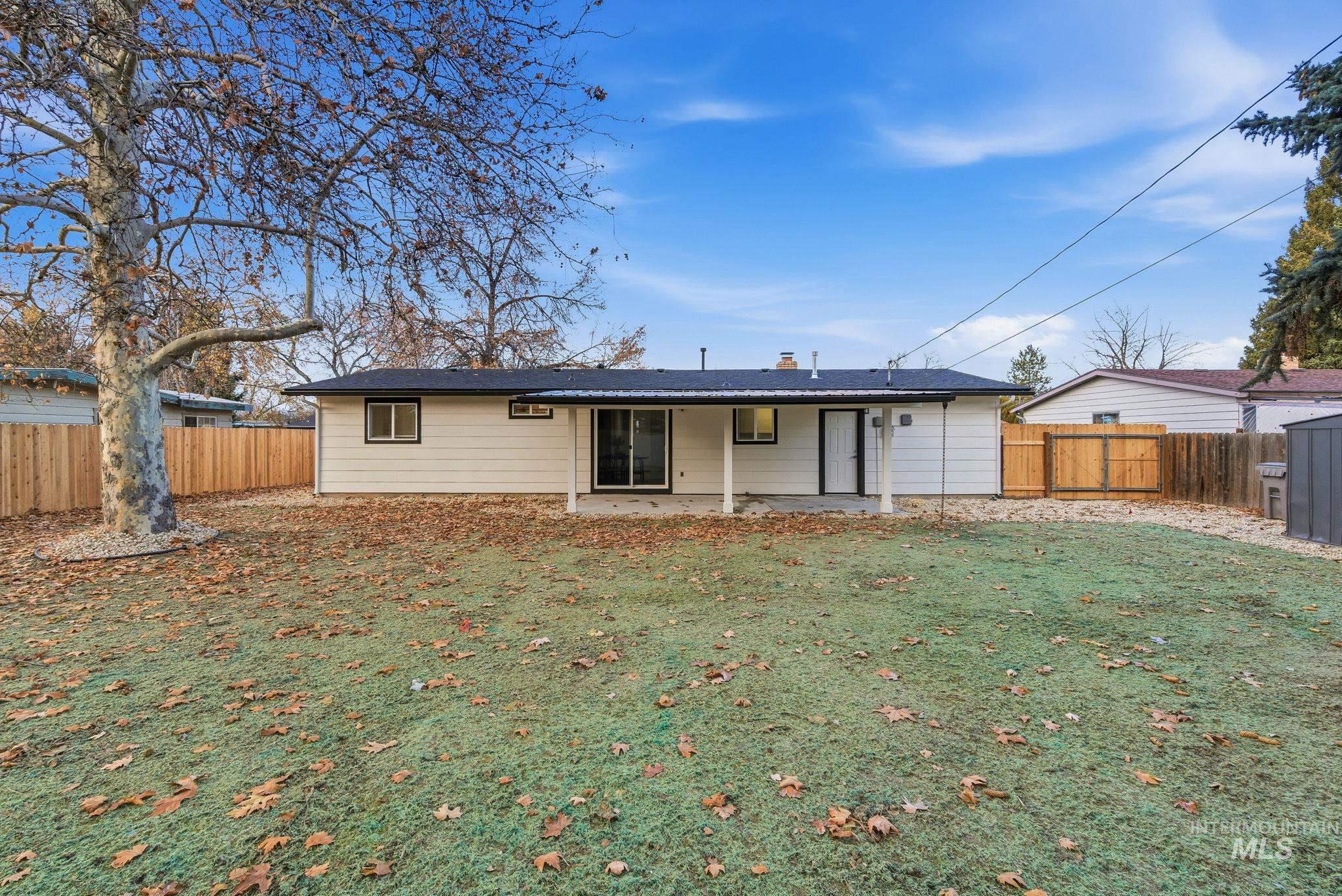 Back of property featuring a fenced backyard and a patio area