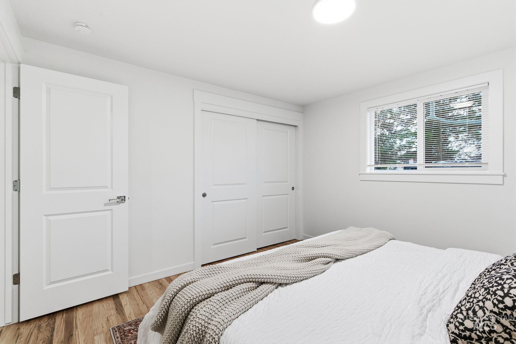 Bedroom featuring a closet and light wood finished floors