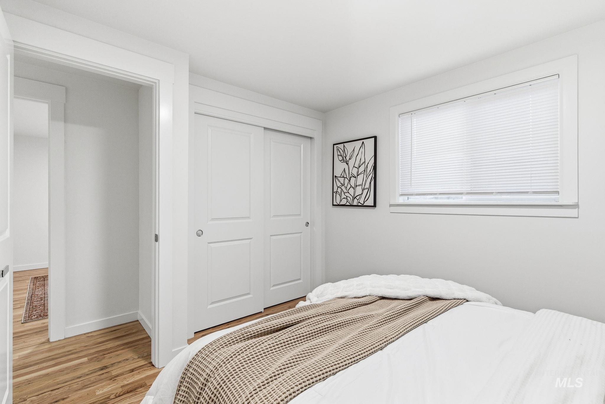 Bedroom featuring a closet and light wood-style floors