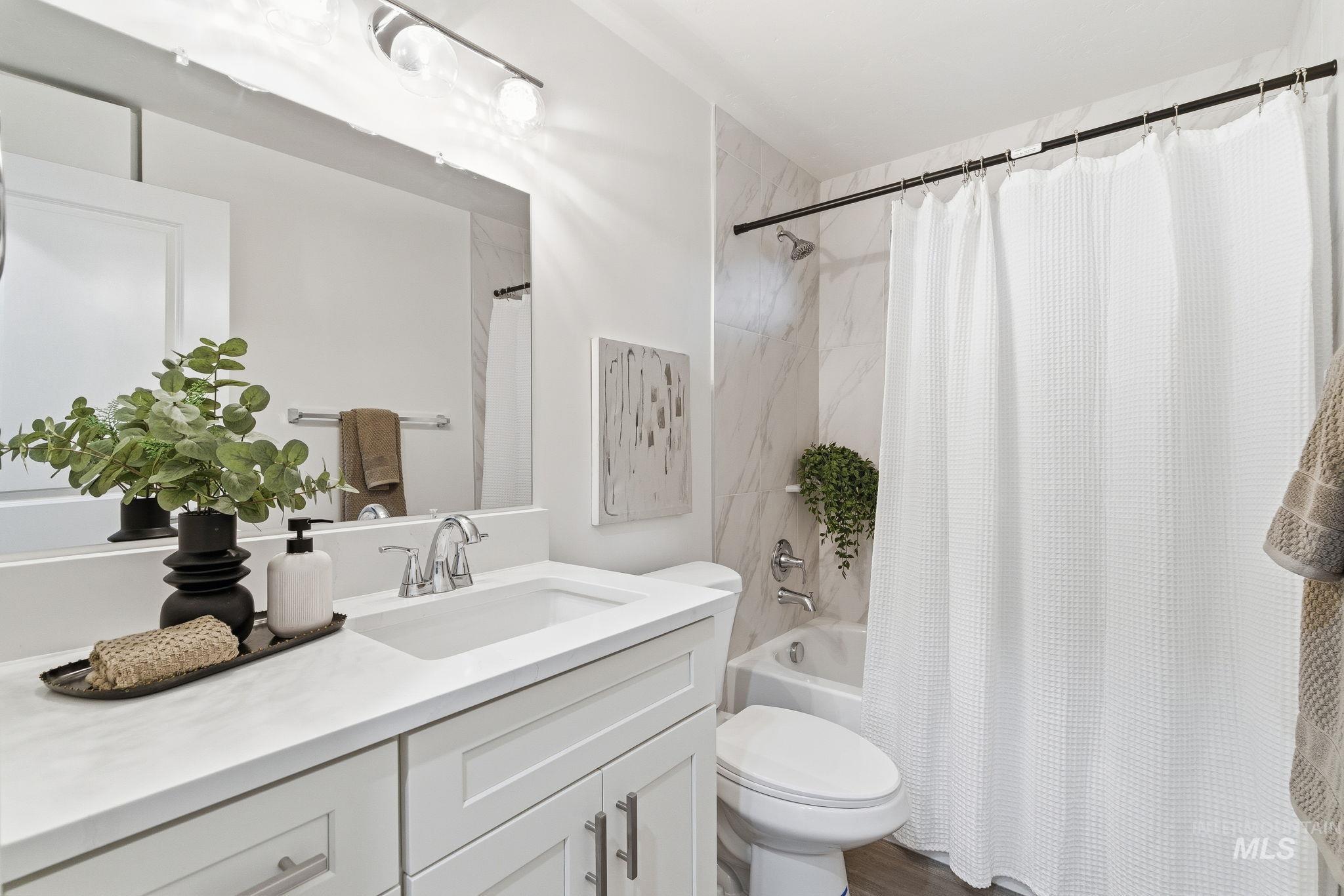 Bathroom with vanity and shower / bathtub combination with curtain