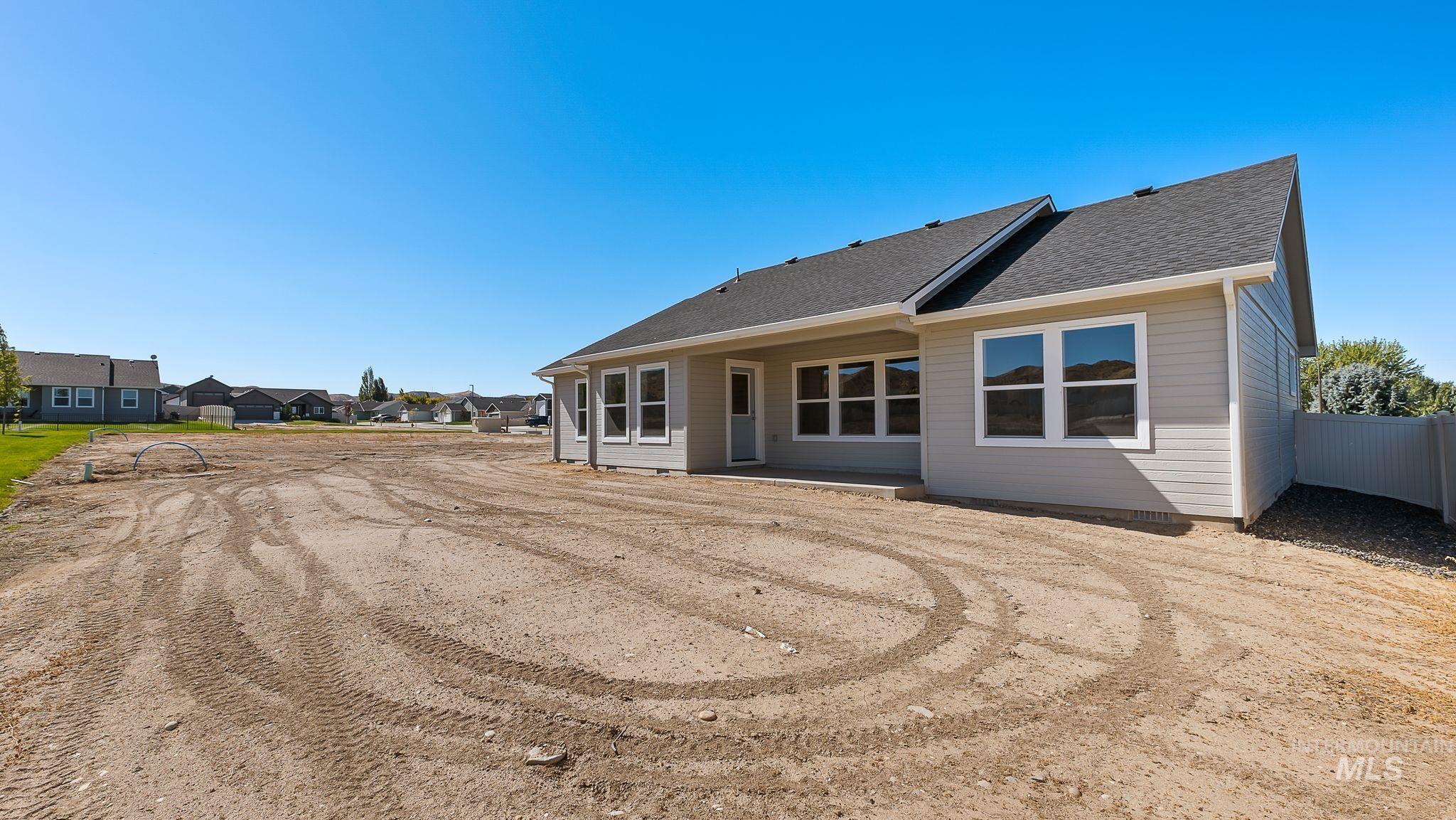 Back of house featuring a patio area and a shingled roof