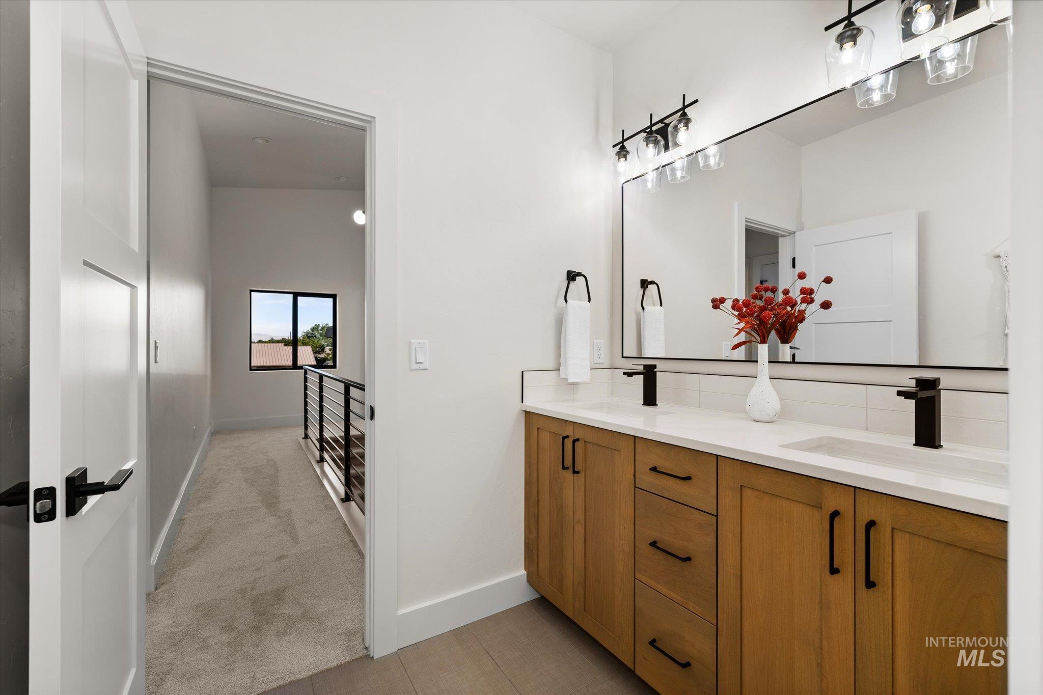 Bathroom featuring double vanity and baseboards