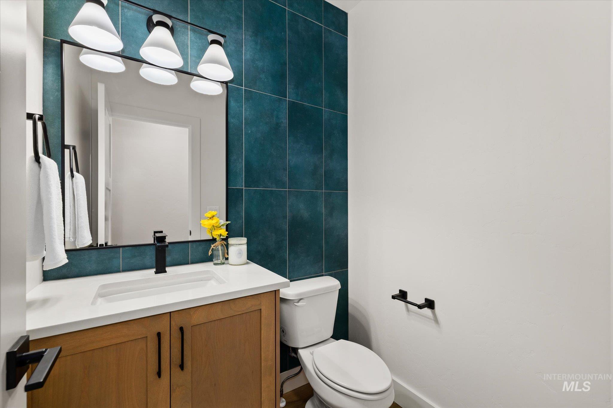 Half bath with vanity and tile walls