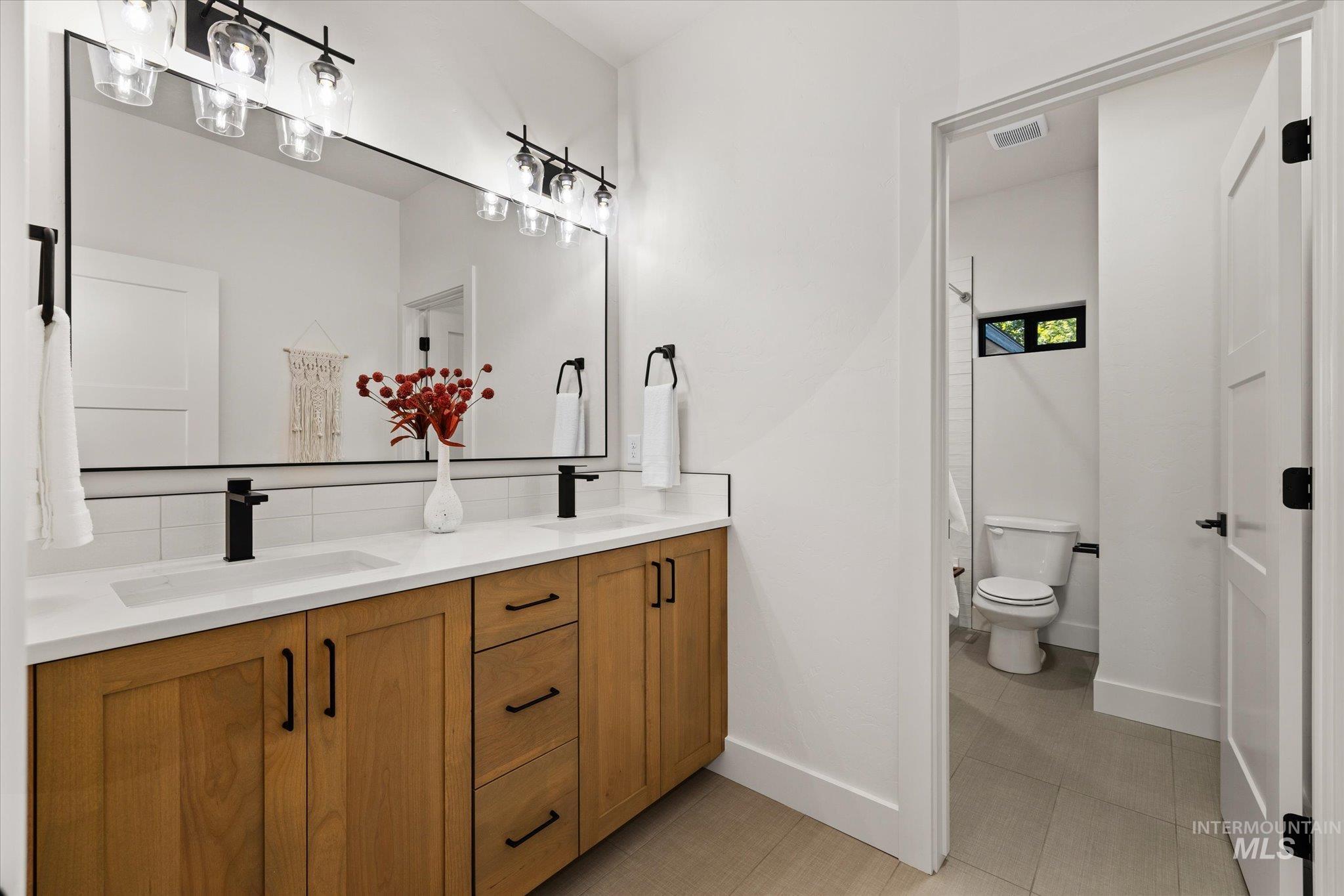 Bathroom featuring double vanity and tile patterned floors